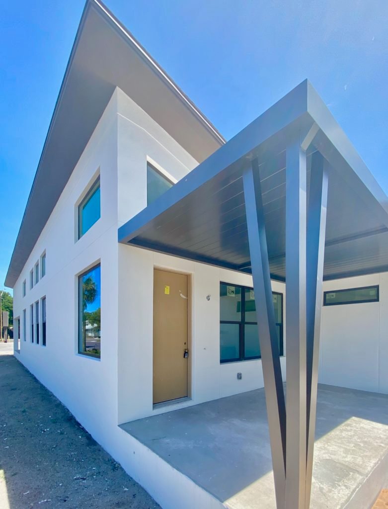 Additionally,This home that is under construction will feature vaulted ceilings throughout. The white white house is trimmed with black accents.