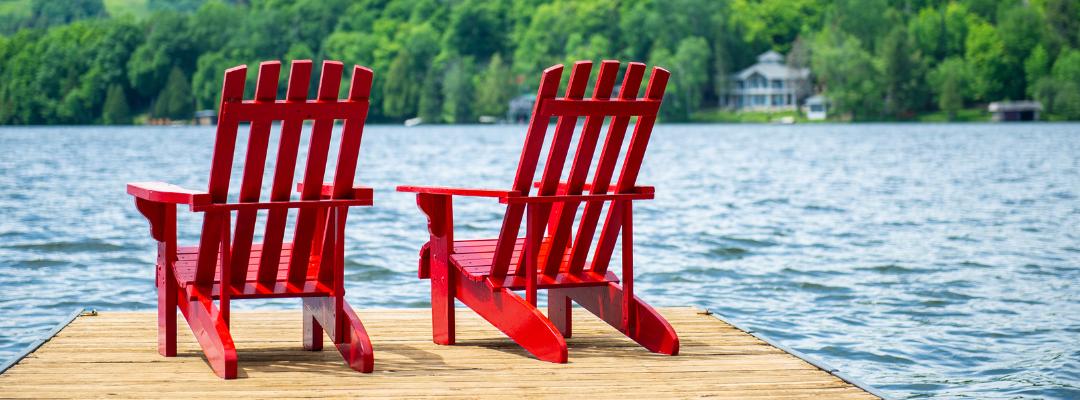 two chairs sitting at the end of a dock
