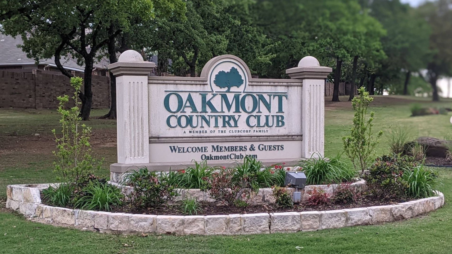 Oakmont Country Club entrance sign under mature oak trees in Corinth, Texas