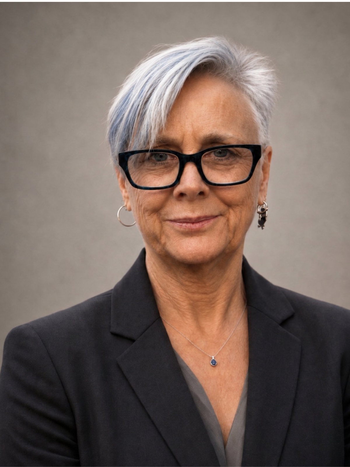 Finkin, wearing black glasses and a dark blazer