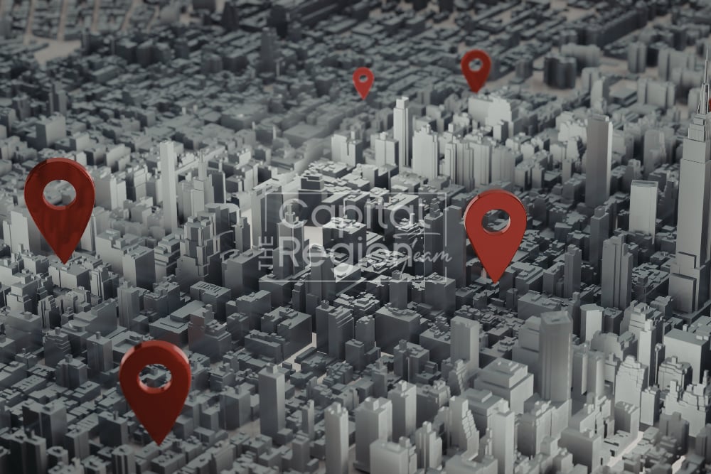 Stylized 3D cityscape marked with red location pins.