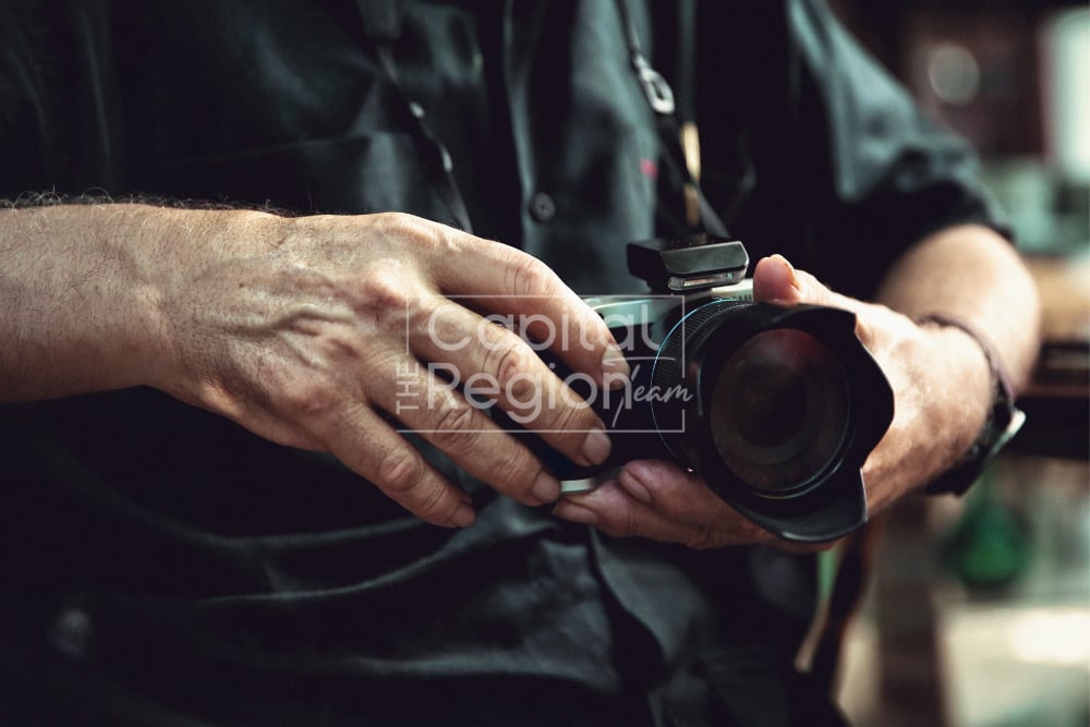 A person holds a professional camera.