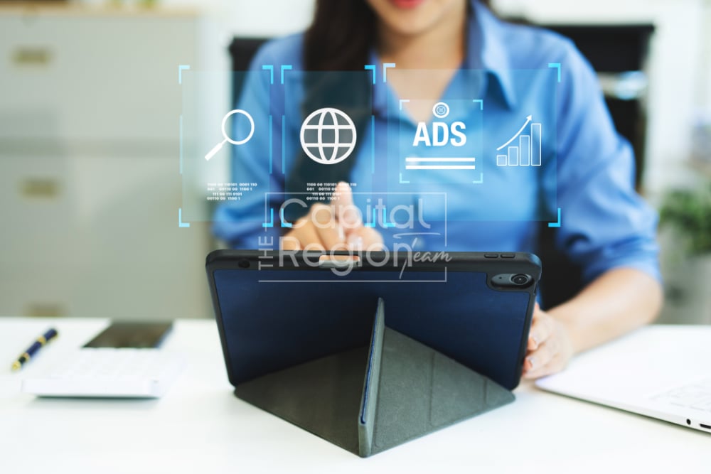 A person uses a tablet beneath digital advertising and analytics icons.