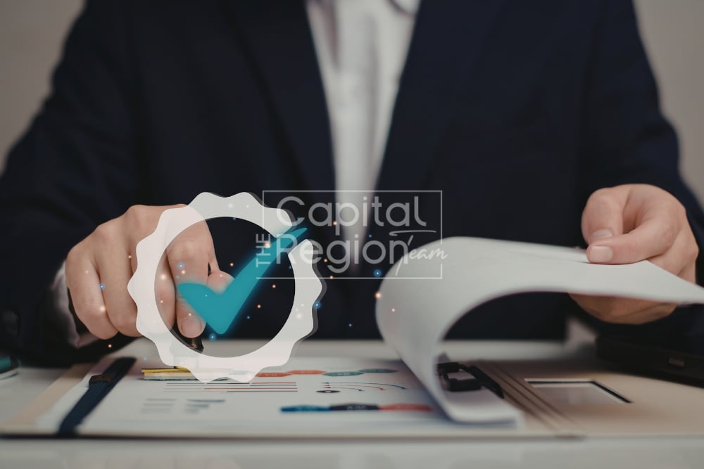 A person reviews financial paperwork beside a checkmark approval graphic.