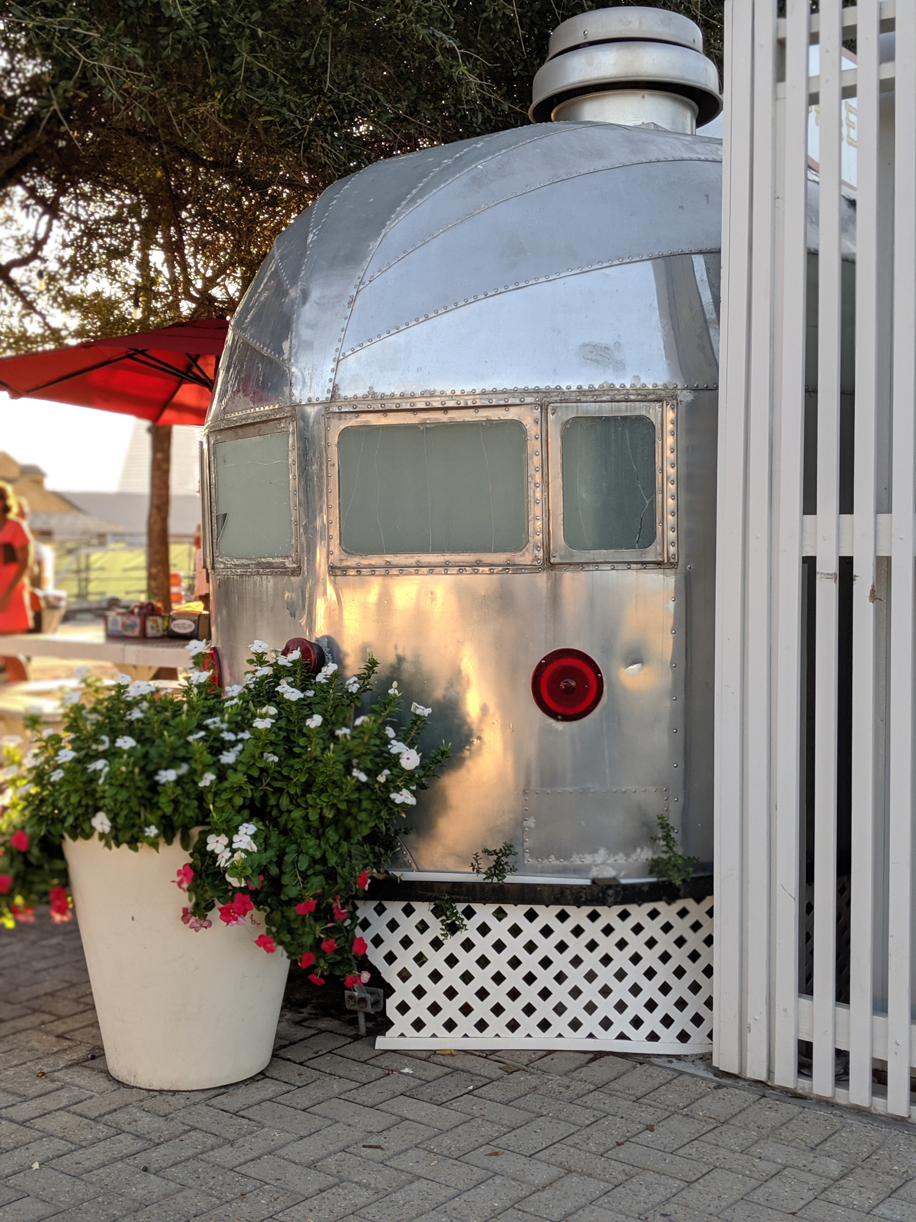 Seaside's Central Square and Airstream food trucks at the market. The town's walkable core is what buyers are really purchasing.
