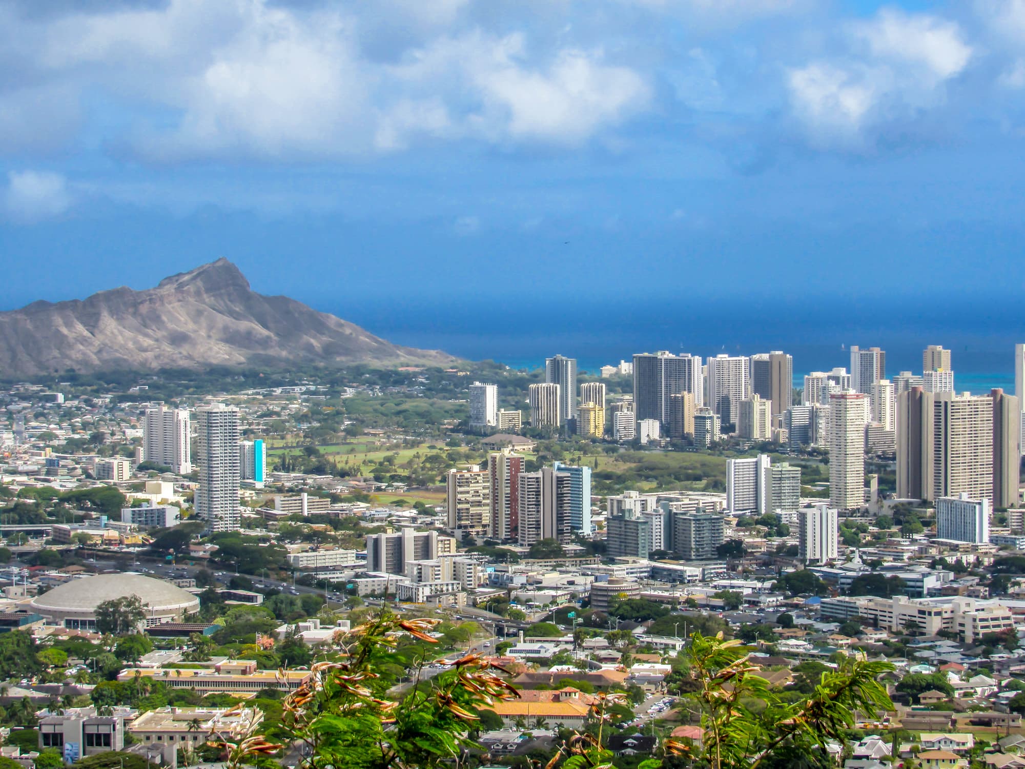 Honolulu skyline and Waikiki high-rises with Diamond Head and the blue Pacific behind them