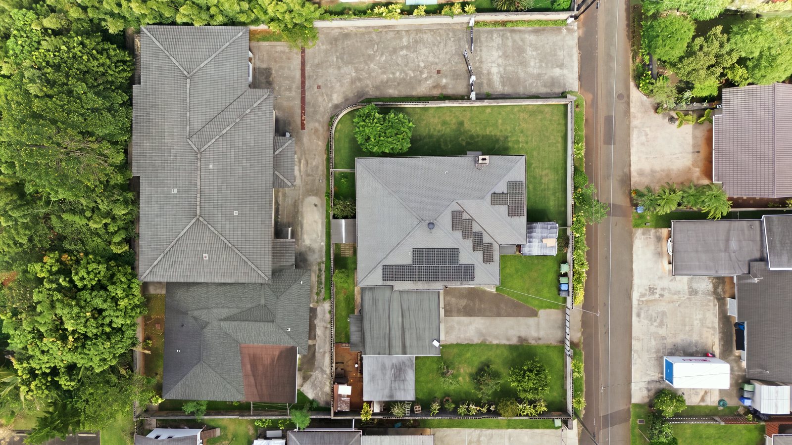 Top-down aerial view of neighboring Honolulu house lots and rooftops