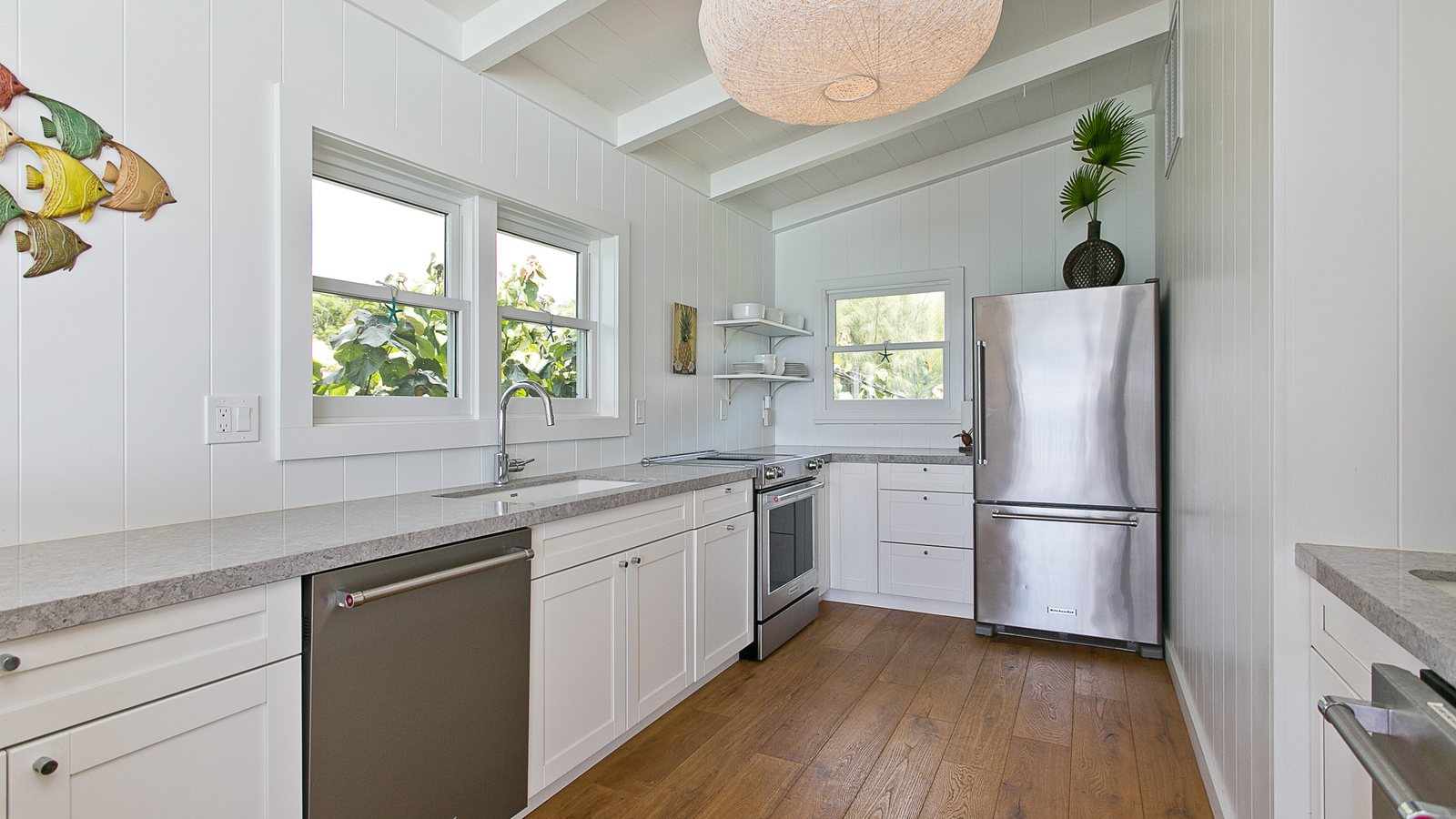 Bright kitchen with white cabinets, wood floors and stainless appliances in a North Shore home
