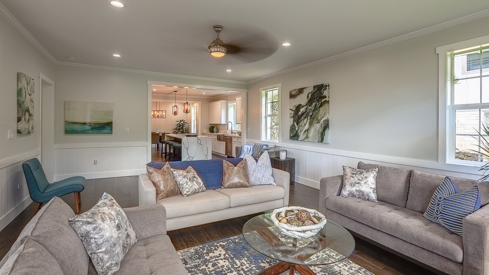 Staged living room with gray sofas and large windows, ready for listing photos