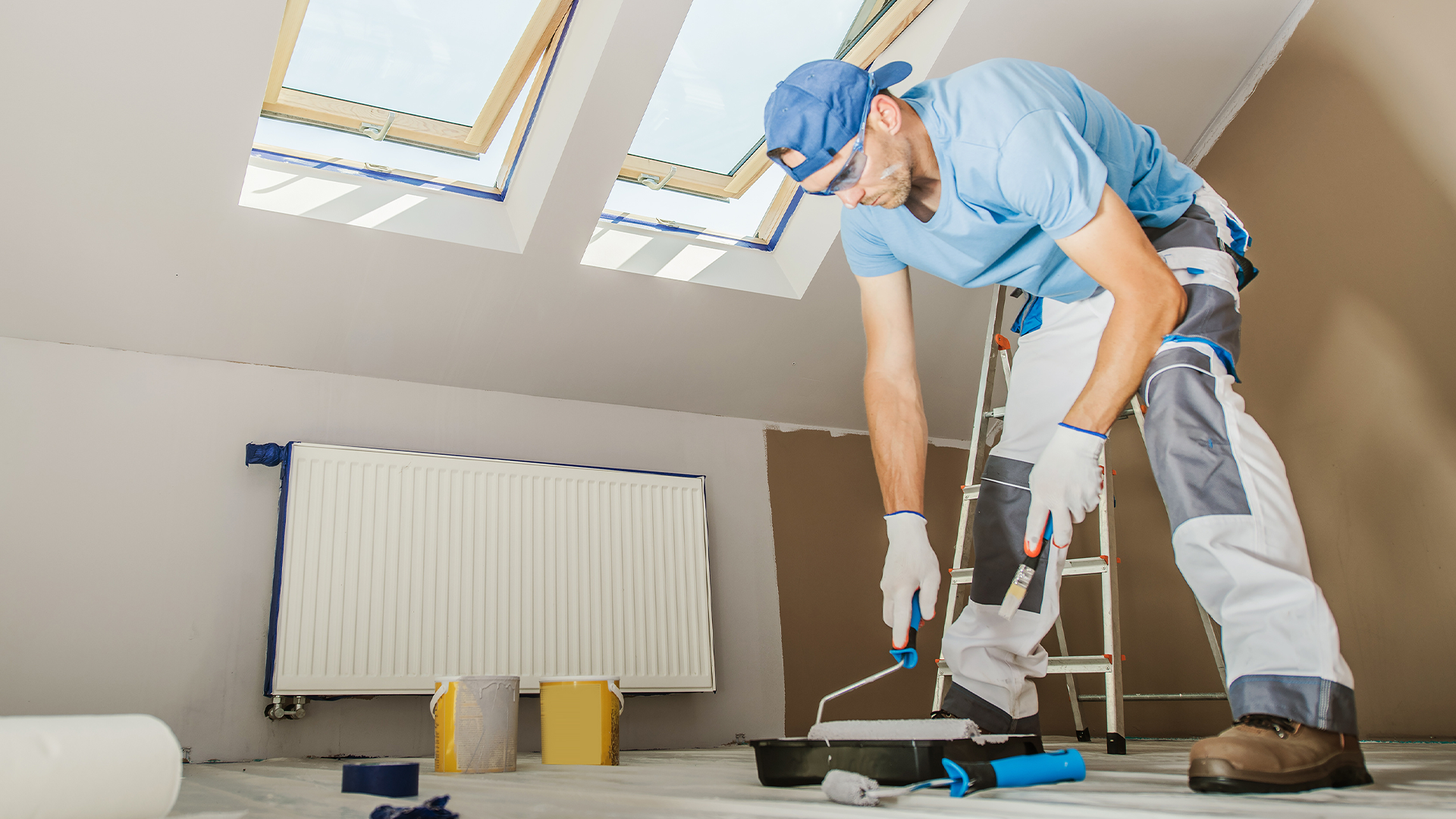 Painter working on home - What Not to Fix When Selling a House