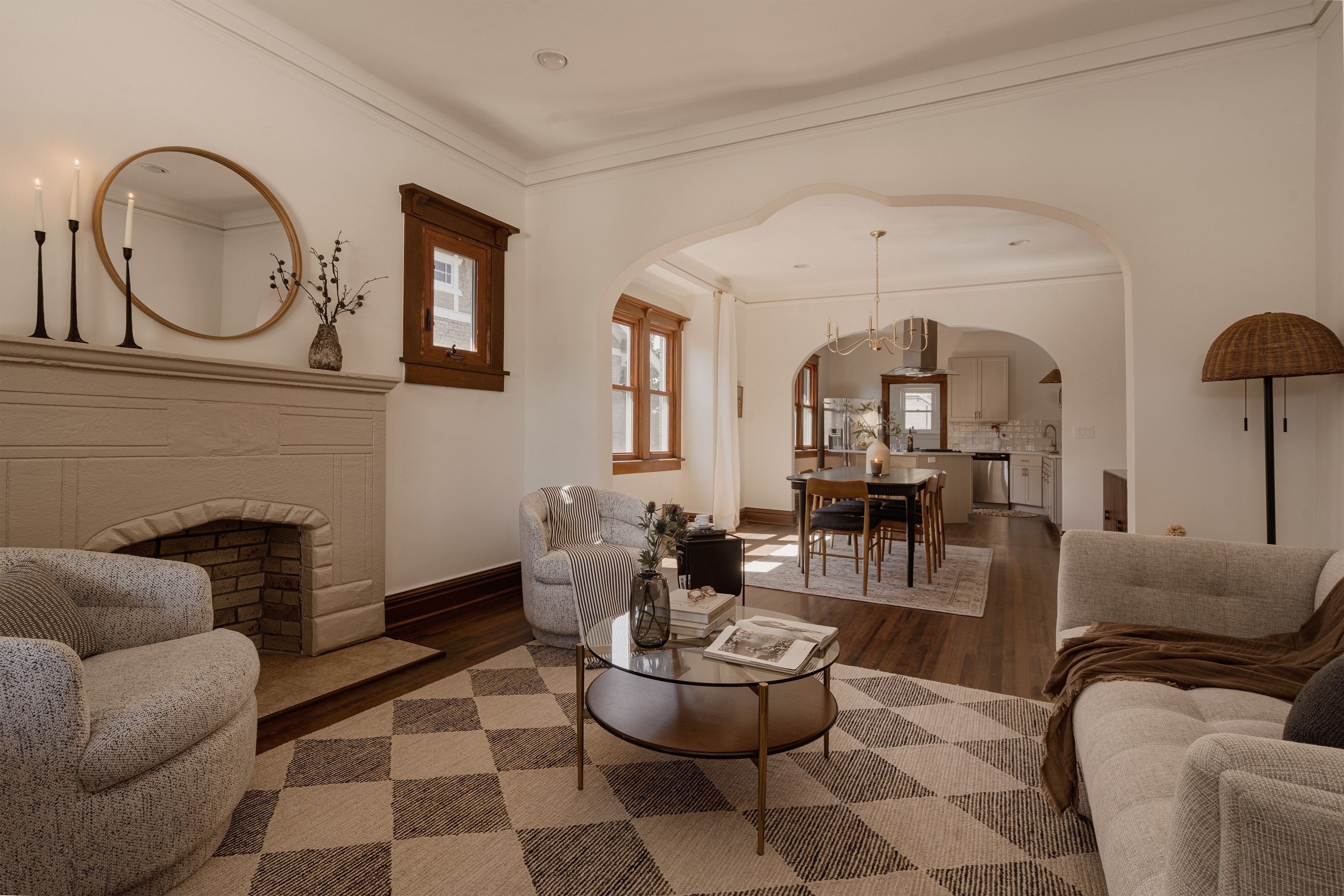 Living room with refinished hardwood floors and a decorative fireplace
