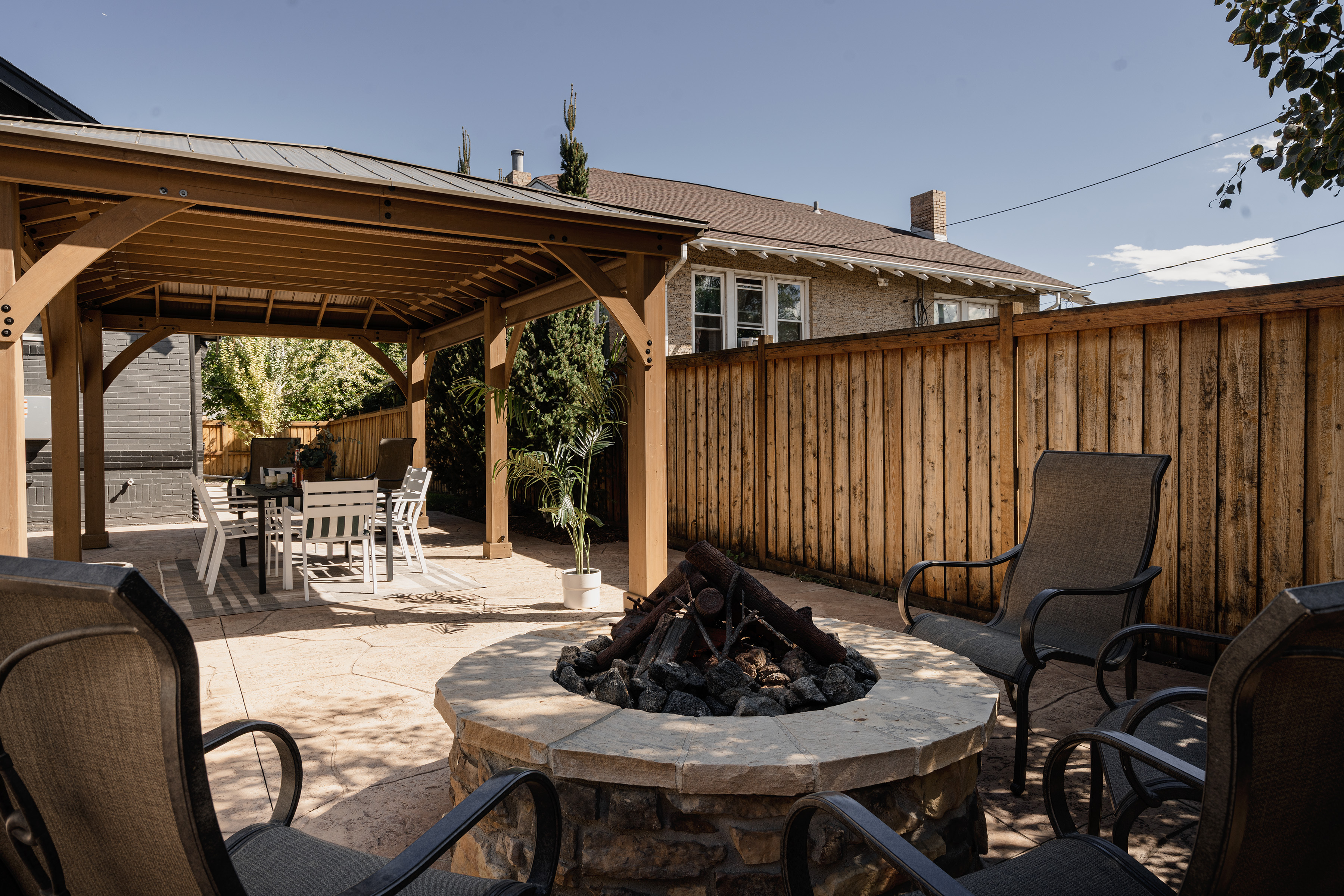 Backyard patio with a covered gazebo and fire pit