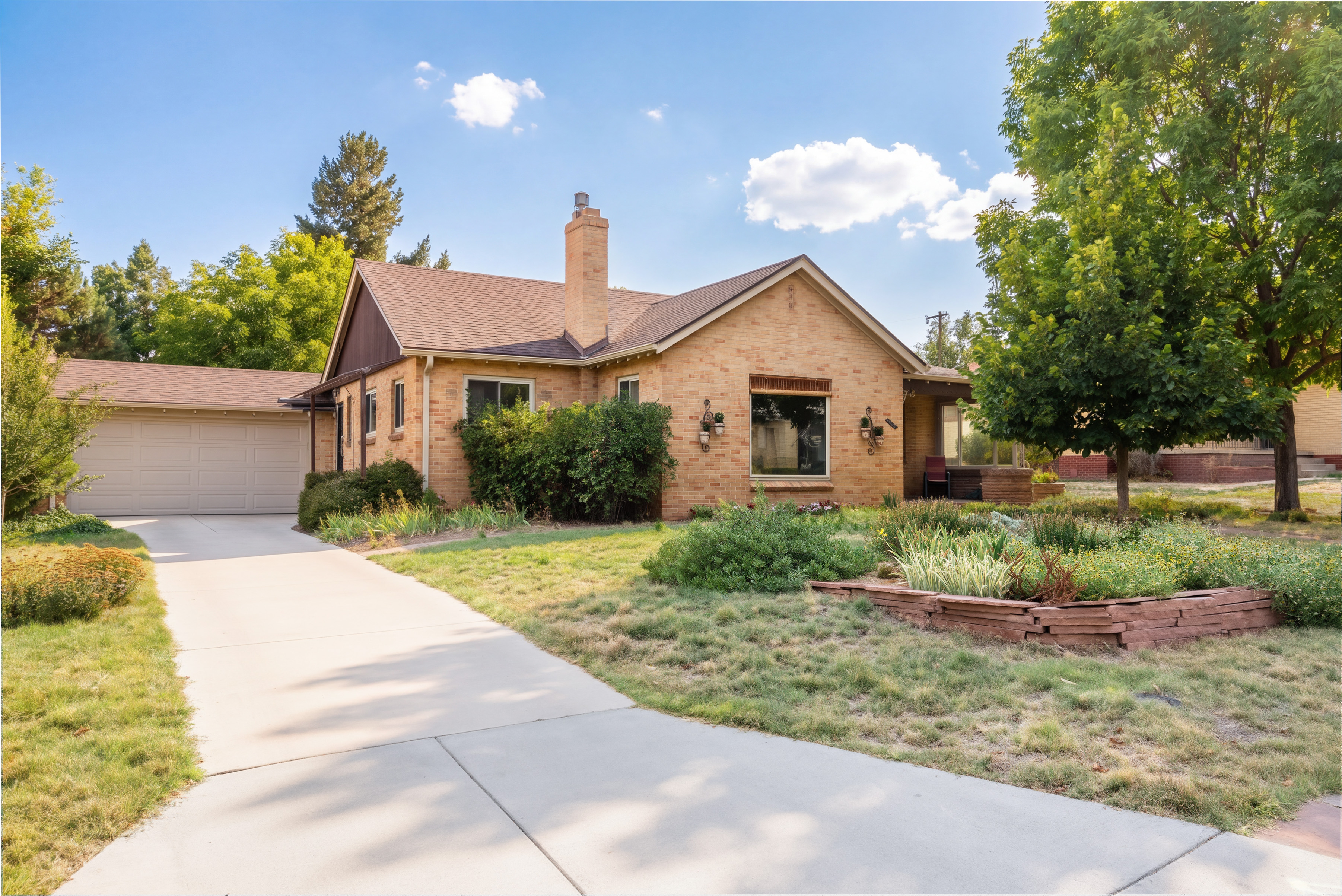 Brick exterior, driveway and landscaping at 2635 Wolff Street in Denver