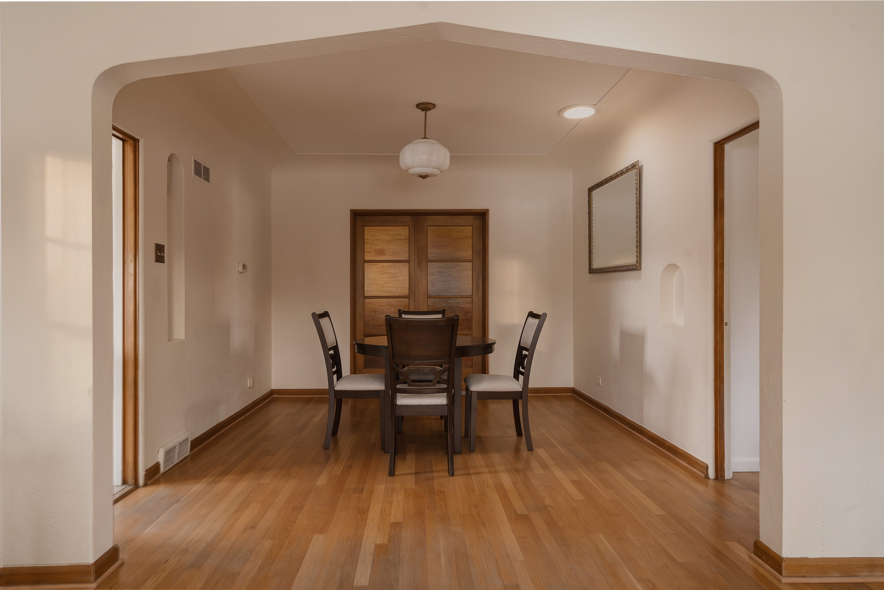 Formal dining room with hardwood floors and an arched opening at 2635 Wolff Street