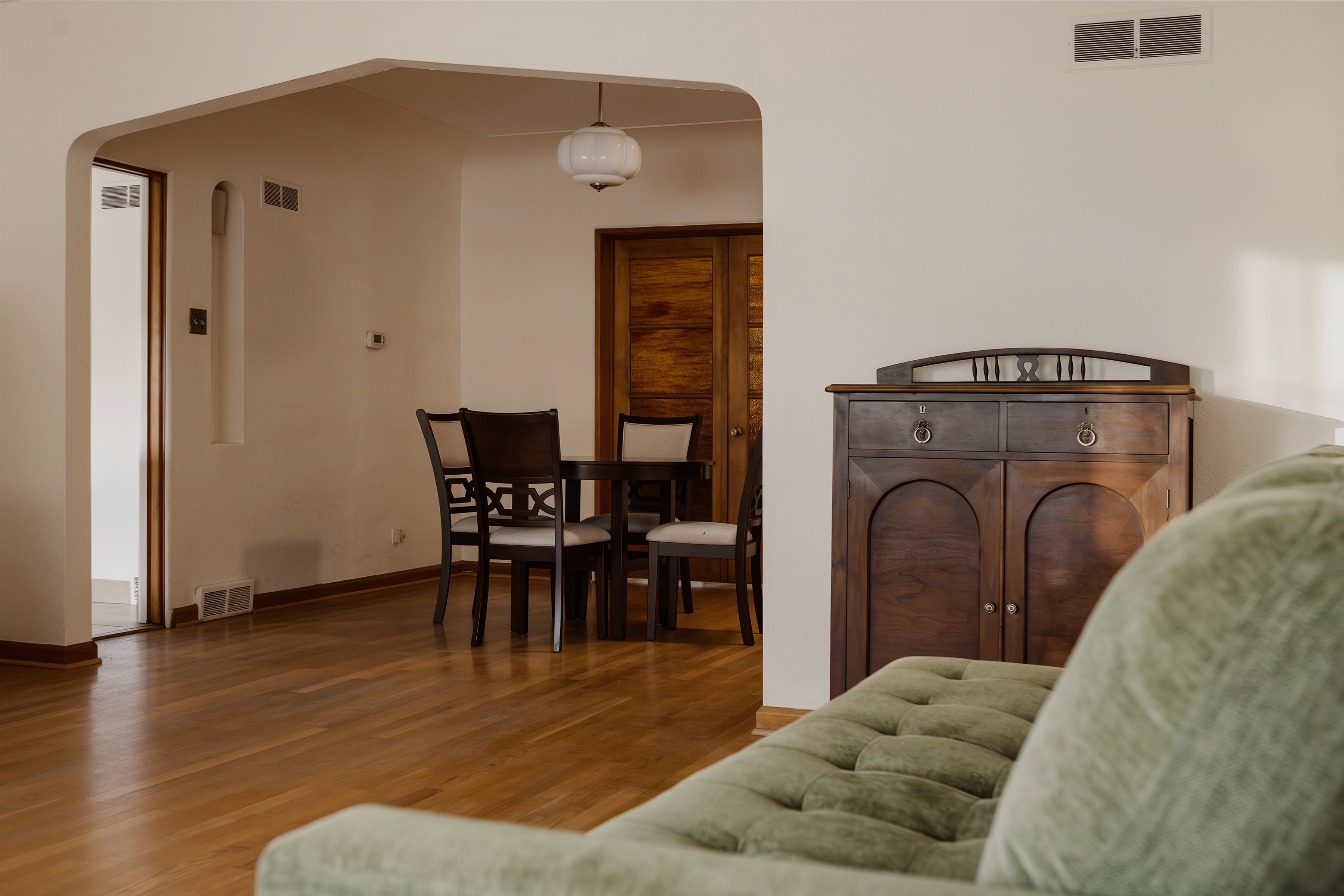 View from the living room through the arched opening to the dining area
