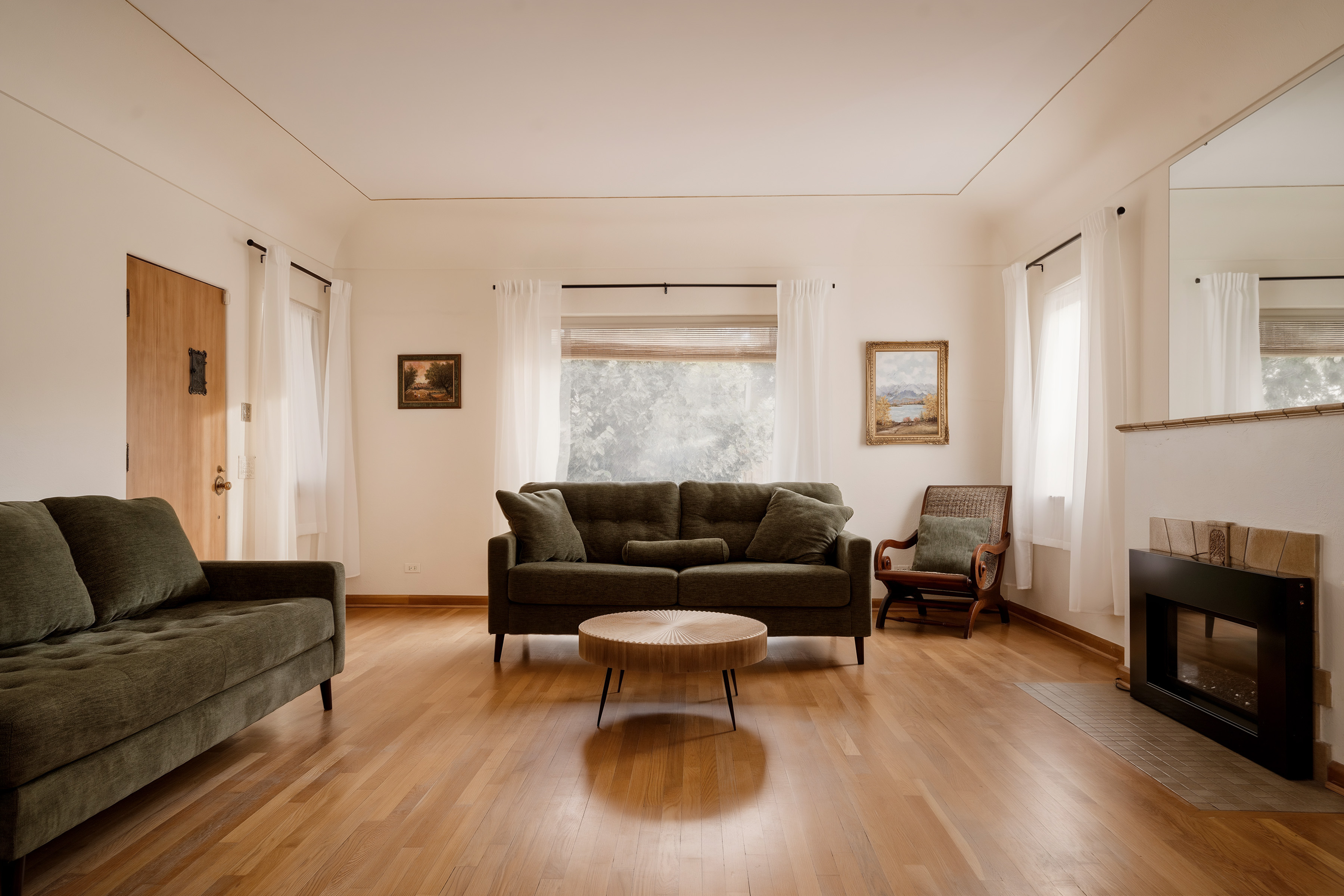 Living room with hardwood floors and a large picture window at 2635 Wolff Street