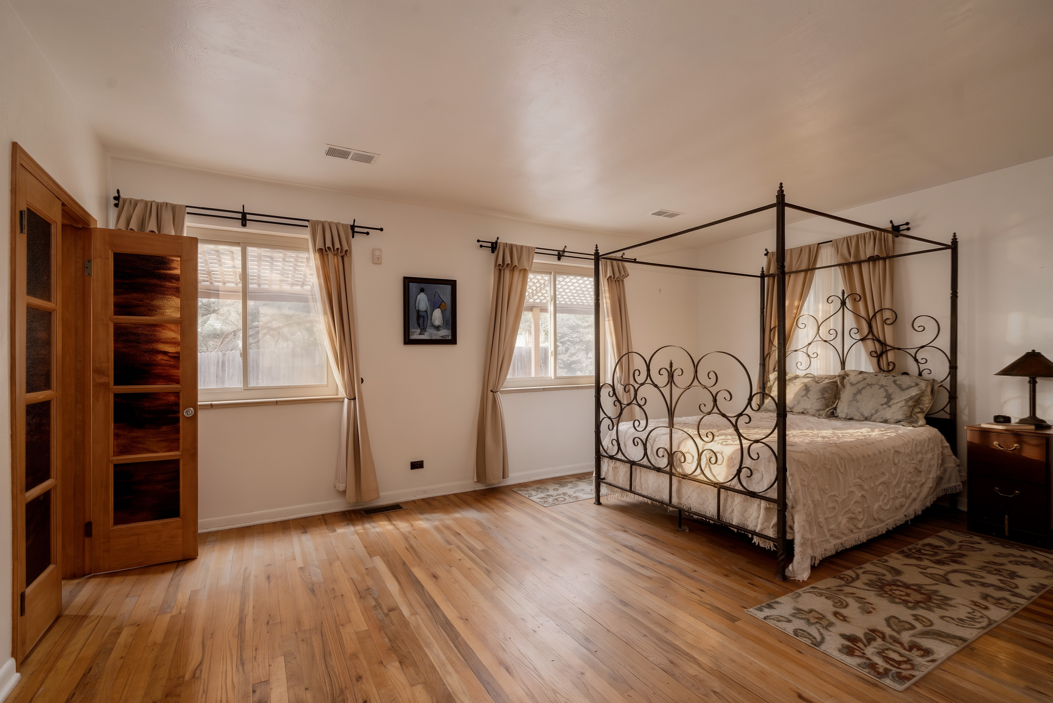 Primary bedroom with hardwood floors and large windows at 2635 Wolff Street