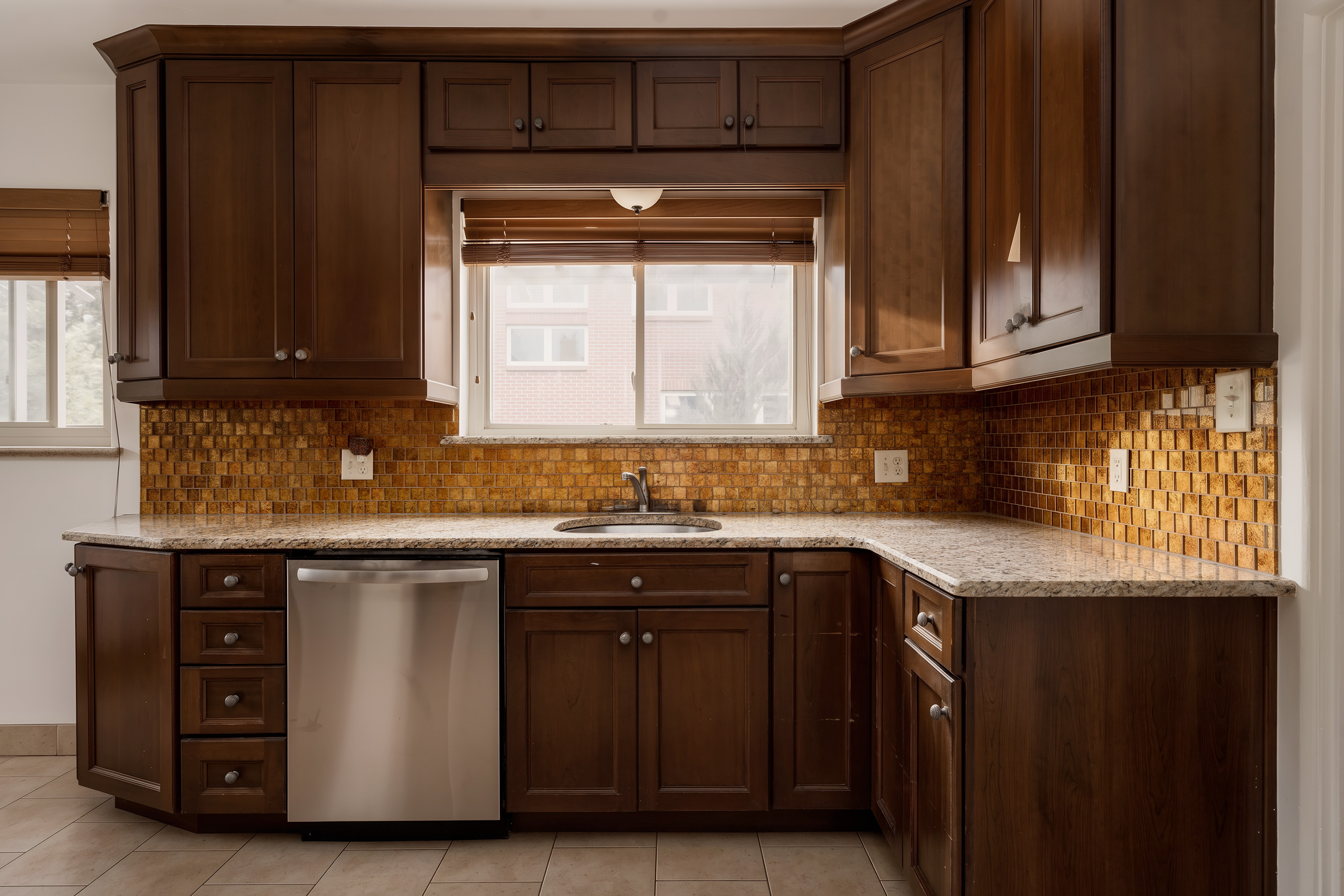 Updated kitchen with granite countertops, wood cabinets and stainless steel dishwasher