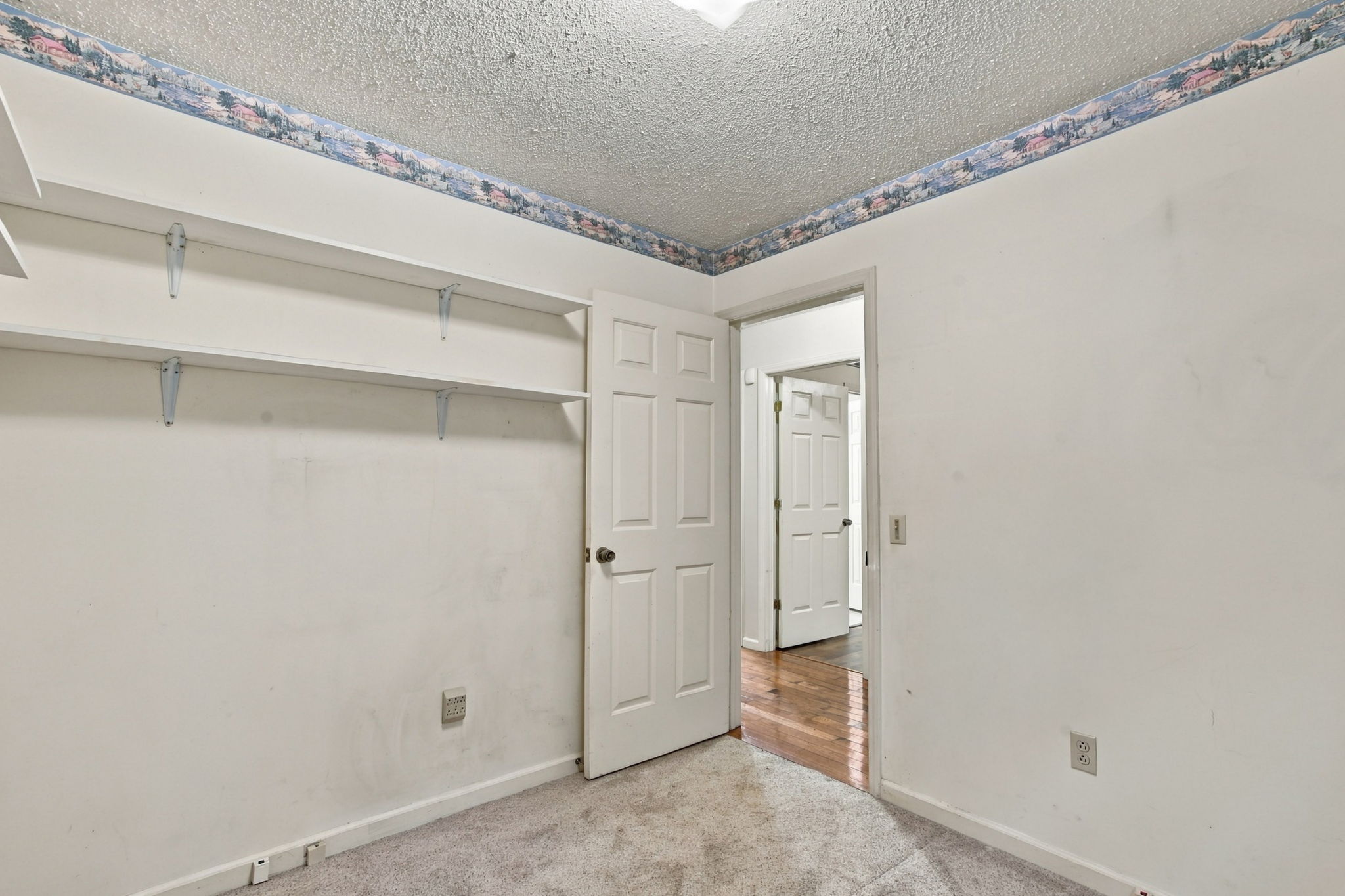Actual unfurnished home office with built-in shelving