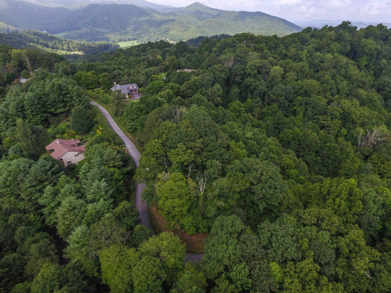 Original drone image of the wooded Daisy Ridge property and surrounding mountain landscape in Valle Crucis