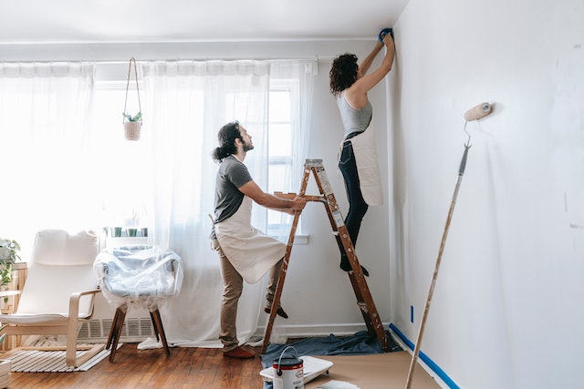 A couple painting walls