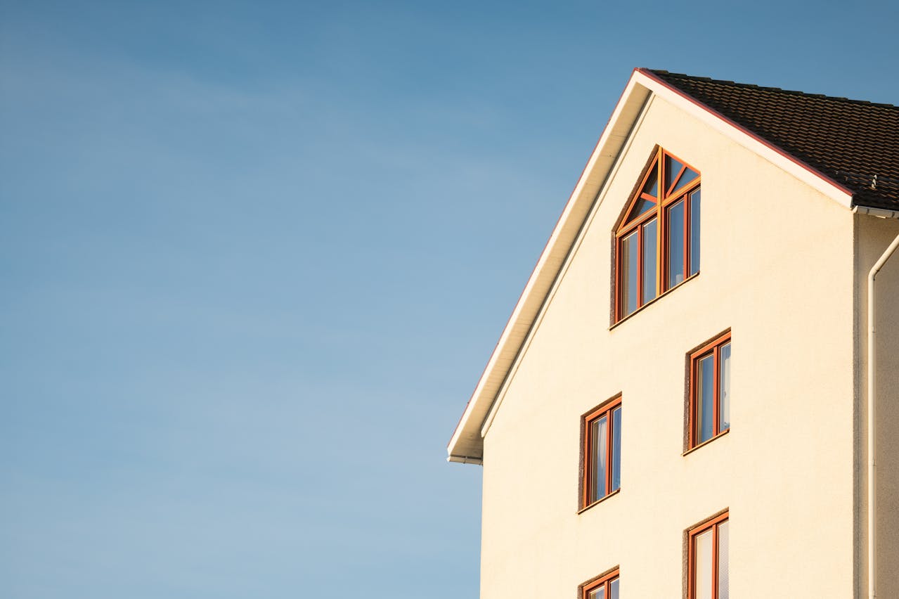 A tall house under a blue sky.