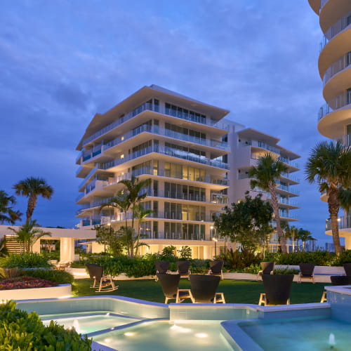 Pier Sixty-Six Residences waterfront elevation at dusk seen from the pool gardens