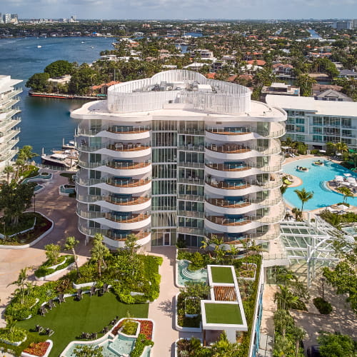Aerial view of the curved terraces and resort pool deck at Pier Sixty-Six Residences