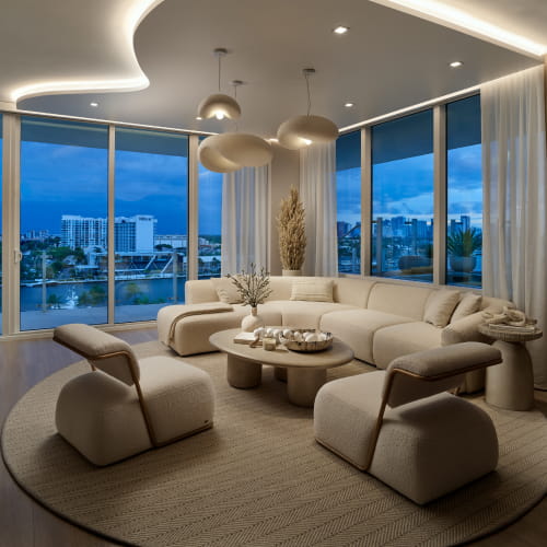 Living and dining room at dusk with curved ceiling detail at Pier Sixty-Six Residences