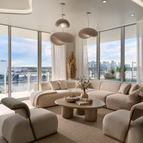 Living room with floor-to-ceiling glass and water views at Pier Sixty-Six Residences