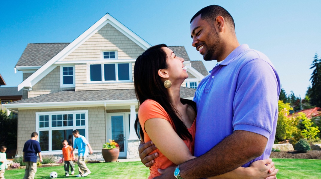 image of a couple in front of a home