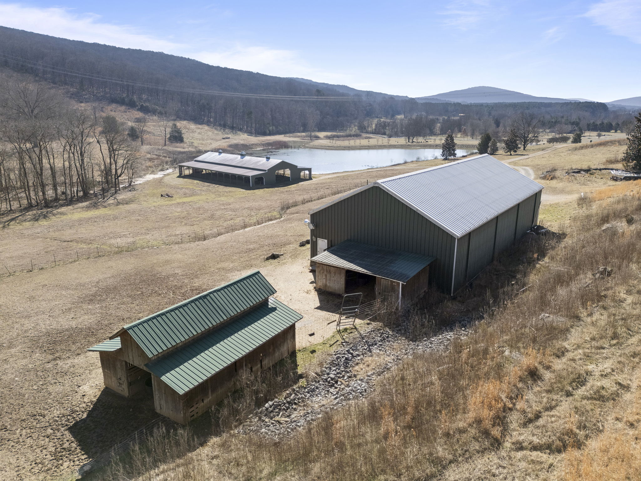 Aerial view of the 40x80 insulated metal workshop and 80x120 barn on the 25-acre tract.