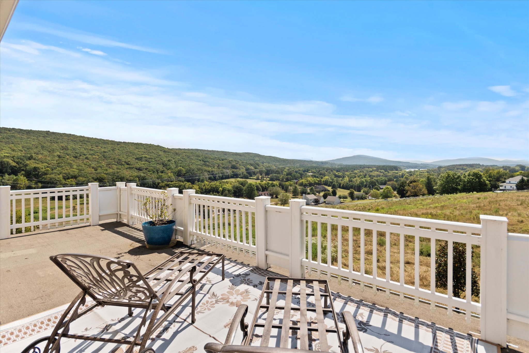 Expansive second-story deck at 129 Victorian Rose Lane with views of the private lake and mountains.