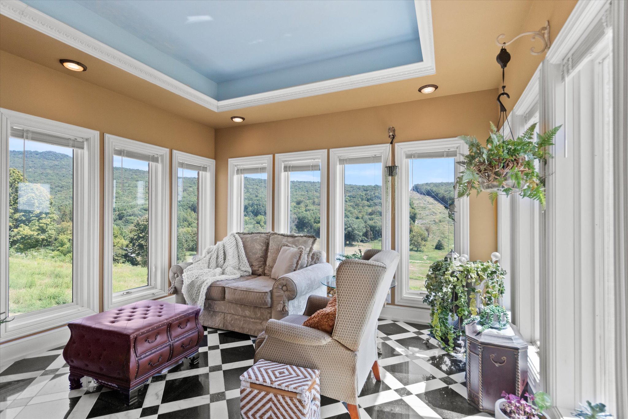 Bright sunroom in the main residence overlooking the equestrian facilities and rolling pastures.