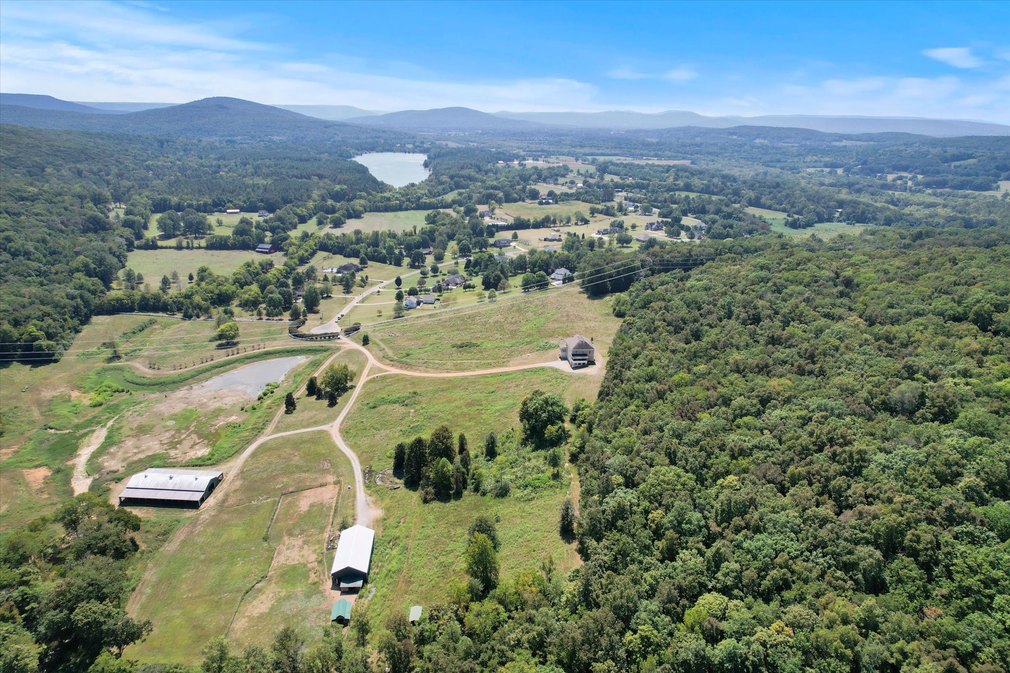 Aerial drone view of Victorian Rose Estates, an 81-acre luxury compound in Madison County, Alabama, showing the residence and workshop.