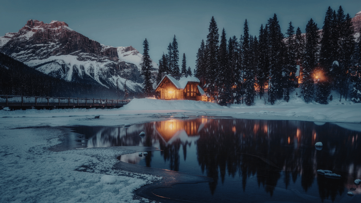 Snow-covered rural home in winter, representing homes for sale in 100 Mile House