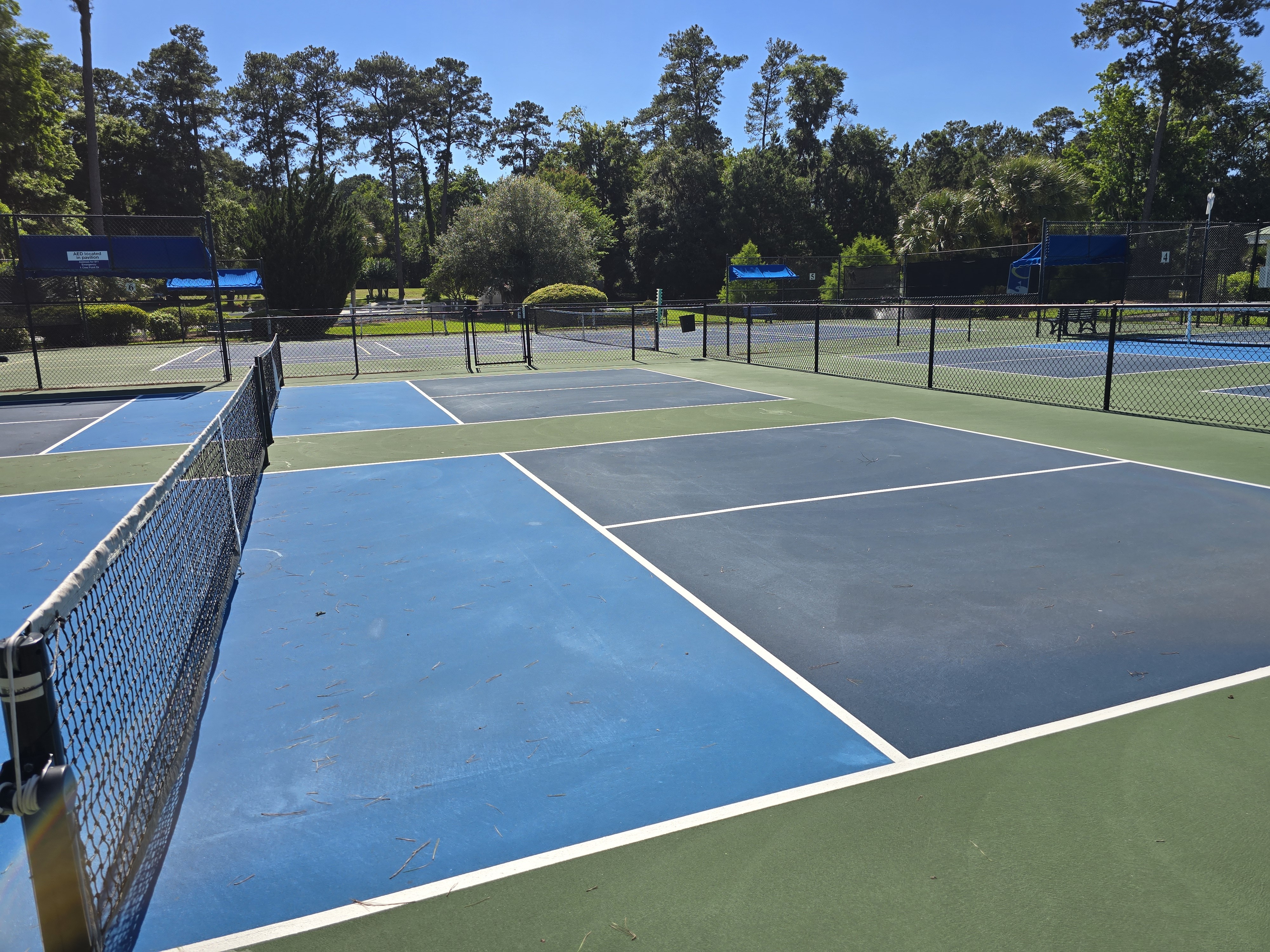 Pickleball courts at The Crescent in Bluffton SC with adjacent tennis courts visible in the background