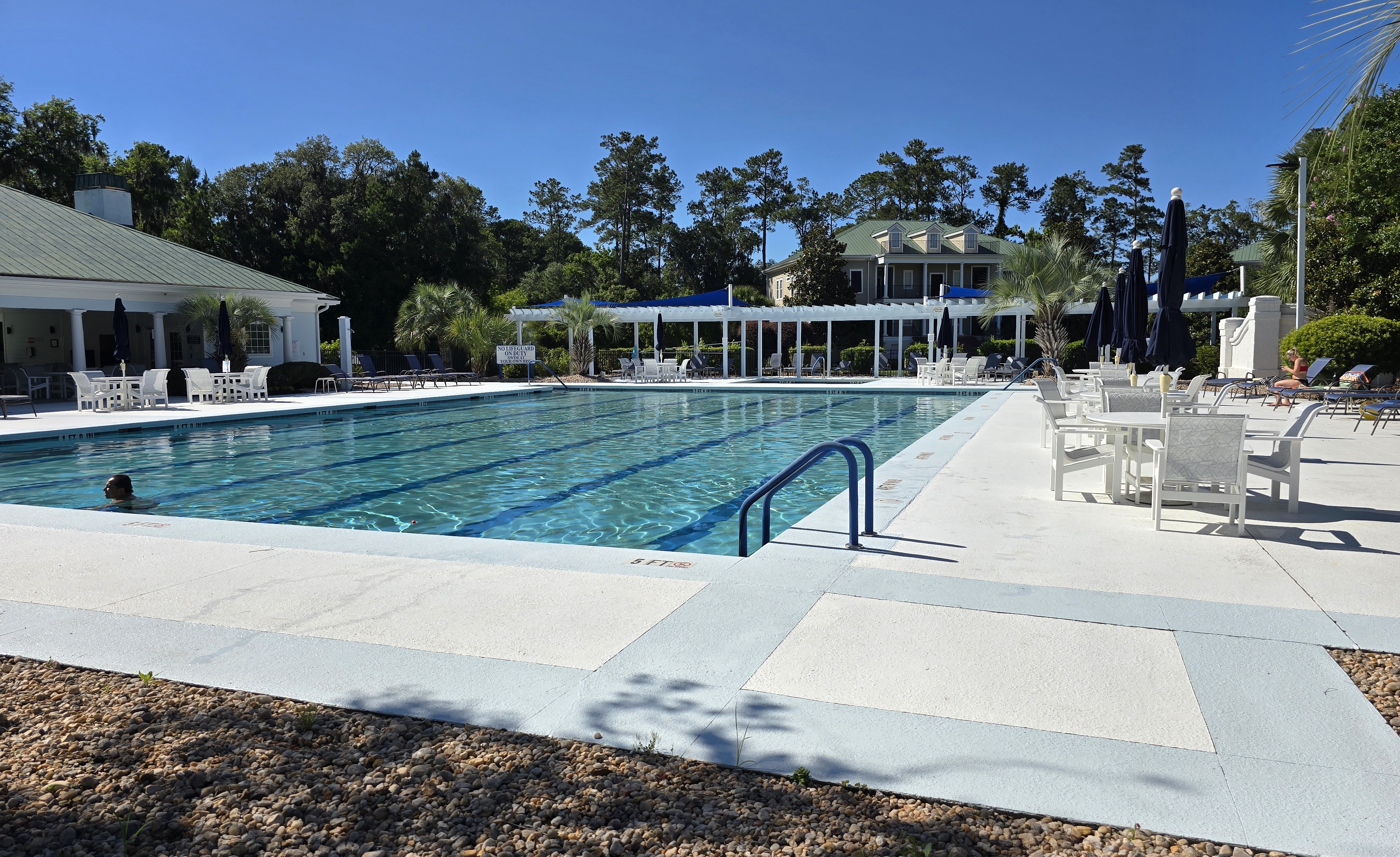 The Crescent community swimming pool in Bluffton SC -- lap lanes, poolside lounge chairs, and pergola shading