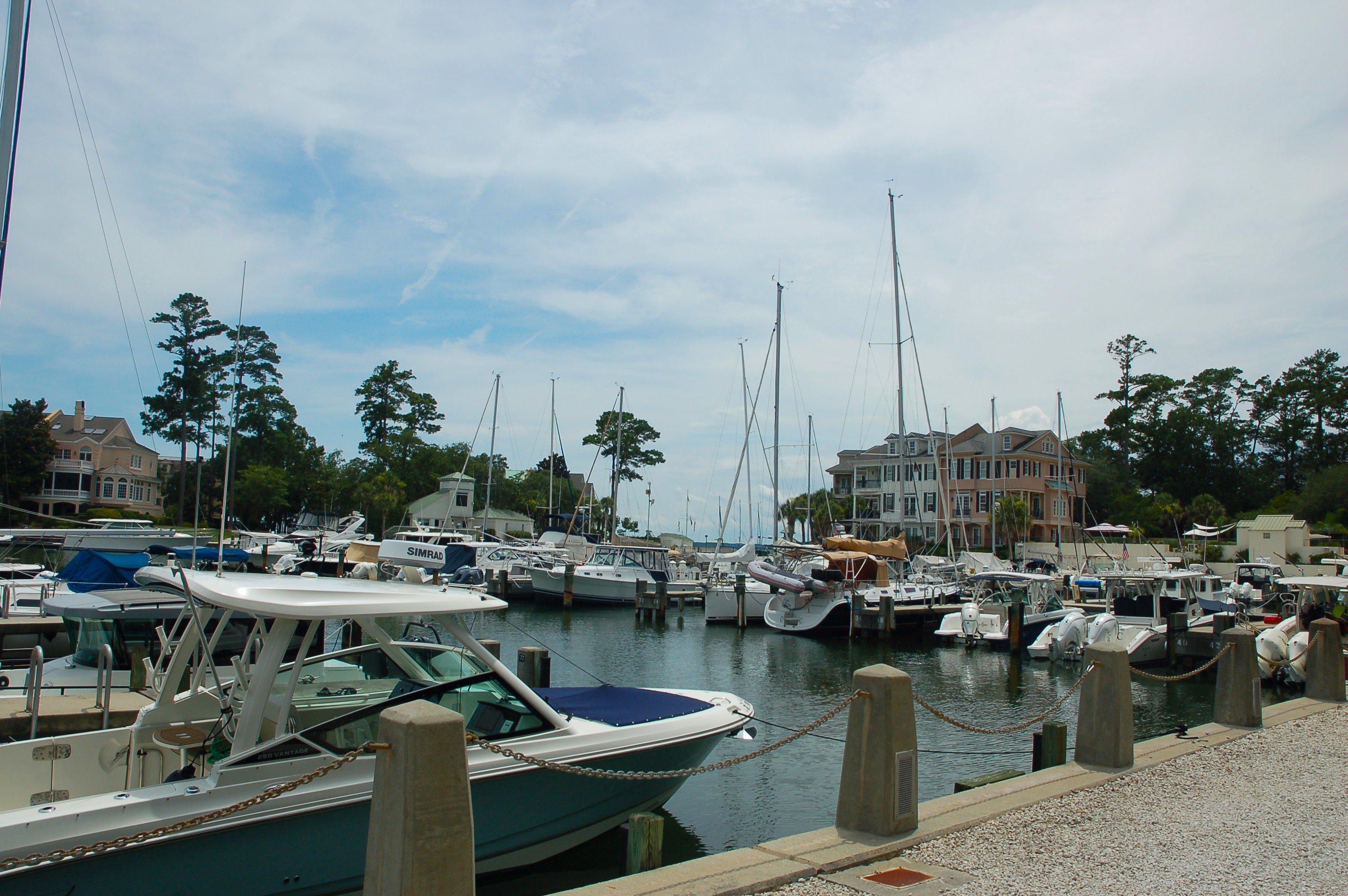 Boats moored in Windmill Harbour Marina with the lock visible in the distance, Hilton Head Island