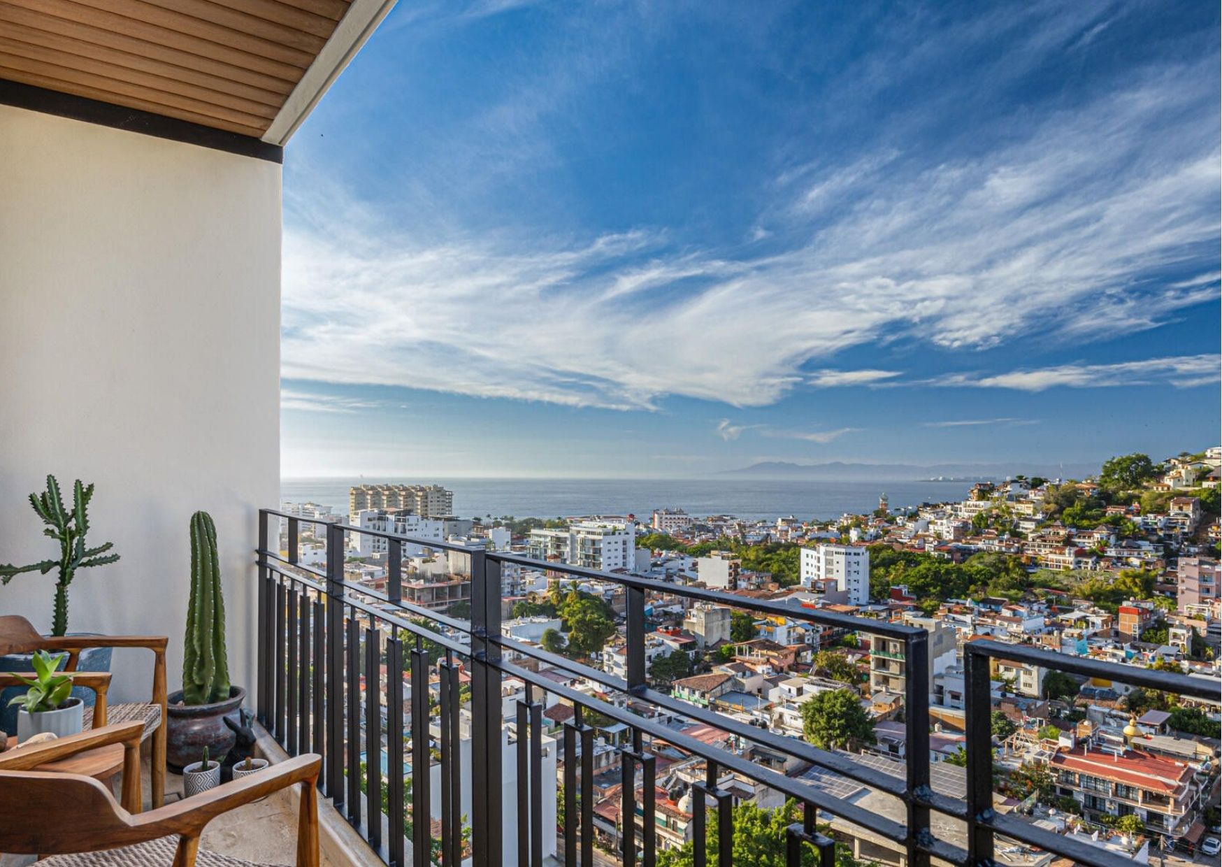 Best neighborhoods for rental income in Puerto Vallarta and Riviera Nayarit, showing beachfront condominiums and marina views across Banderas Bay