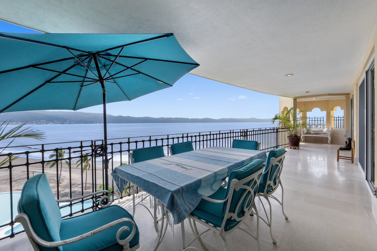 Covered terrace dining table facing Banderas Bay at Bay View Grand A-601