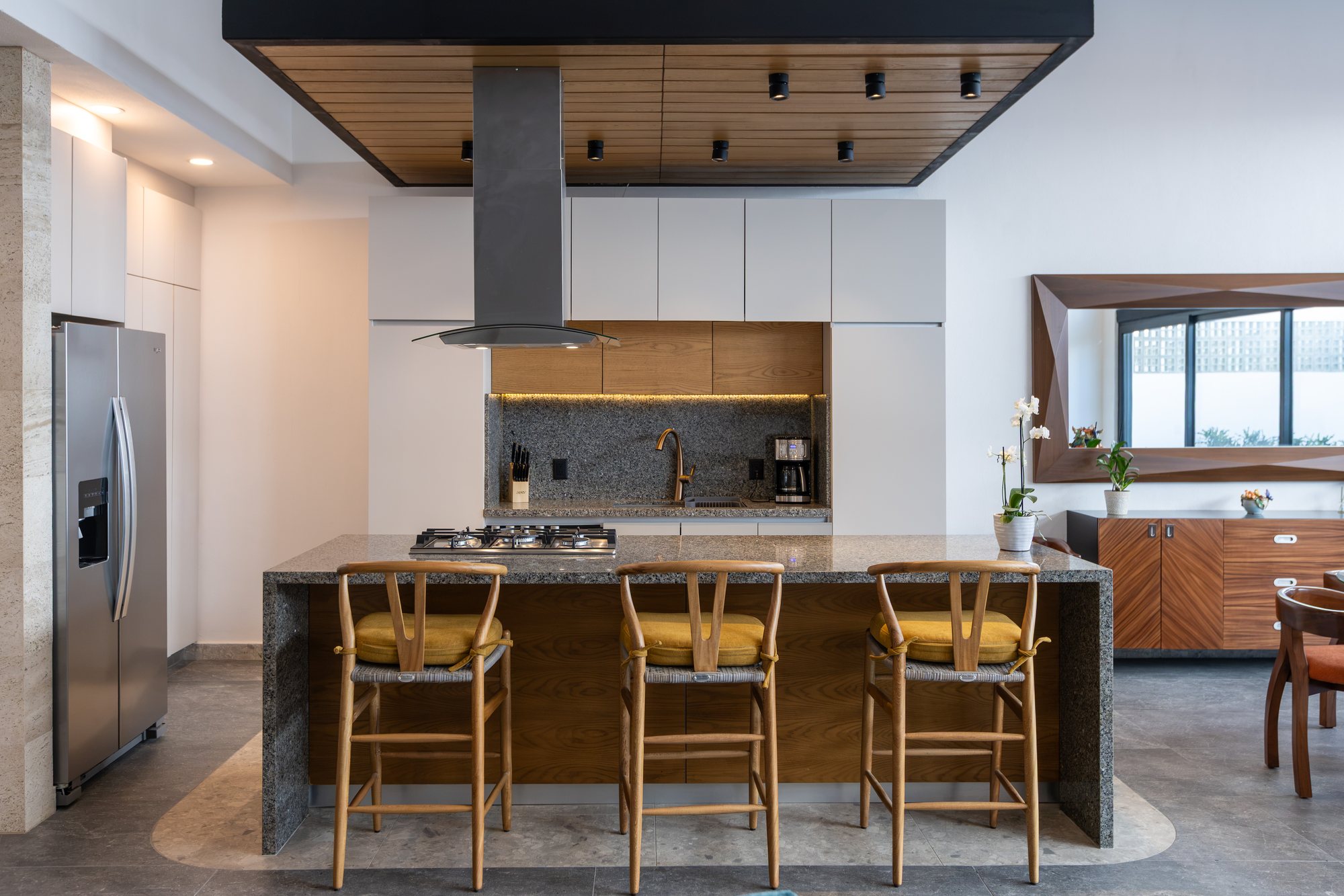 Kitchen with a gas cooktop, breakfast bar and stainless refrigerator