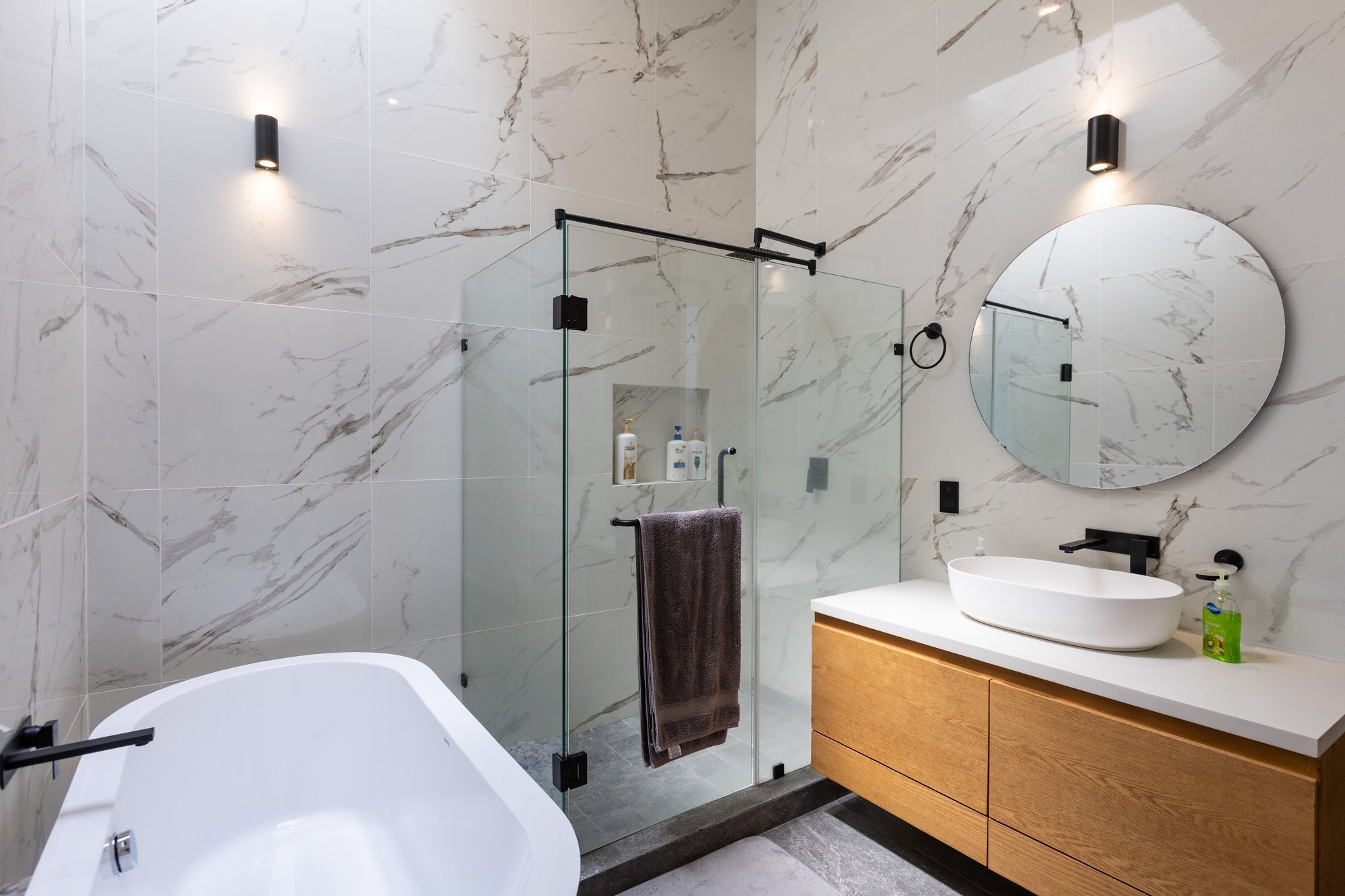 Primary bath with a freestanding tub, glass shower and floating vanity