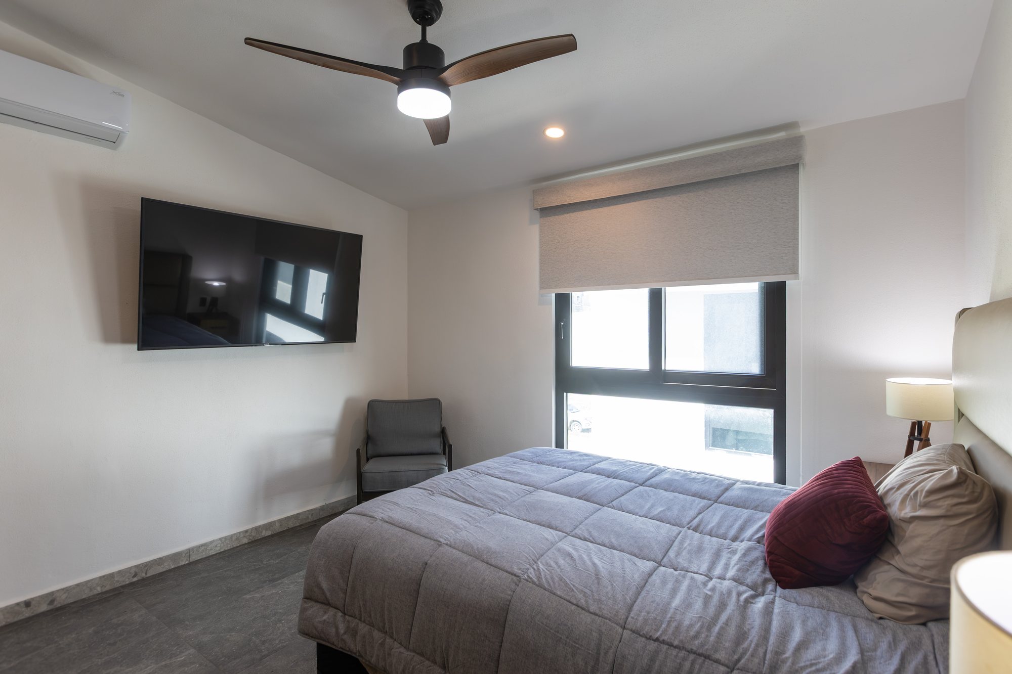 Bedroom with a ceiling fan, mini-split and window