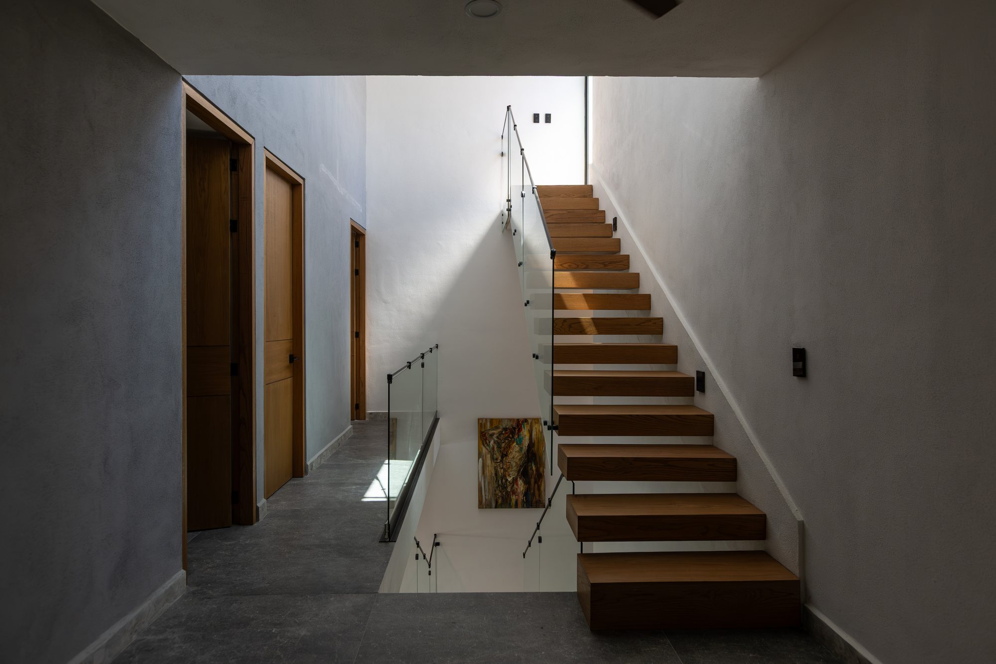 Floating wood staircase up to the rooftop