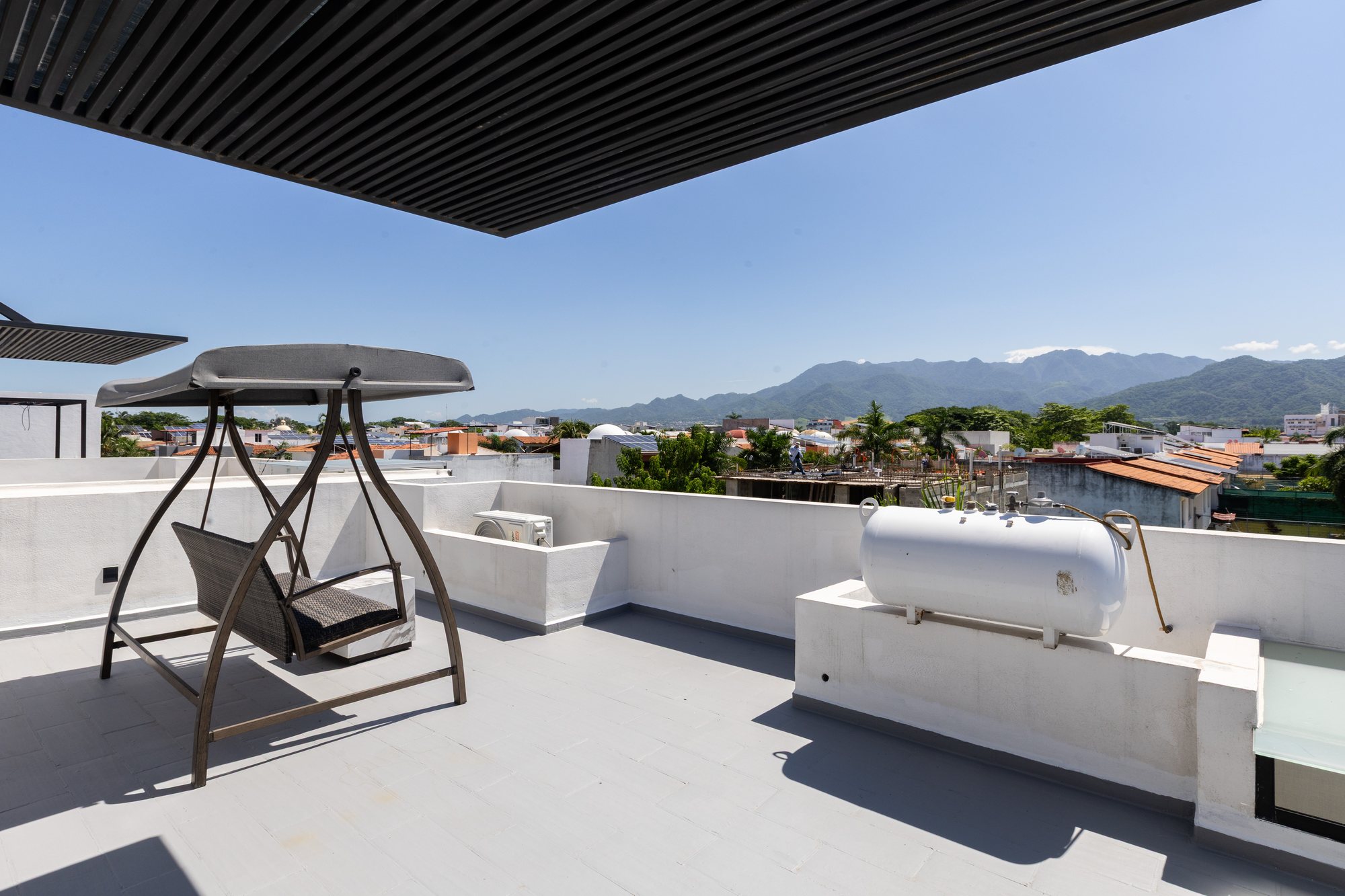 Rooftop terrace with a swing and a view of the mountains