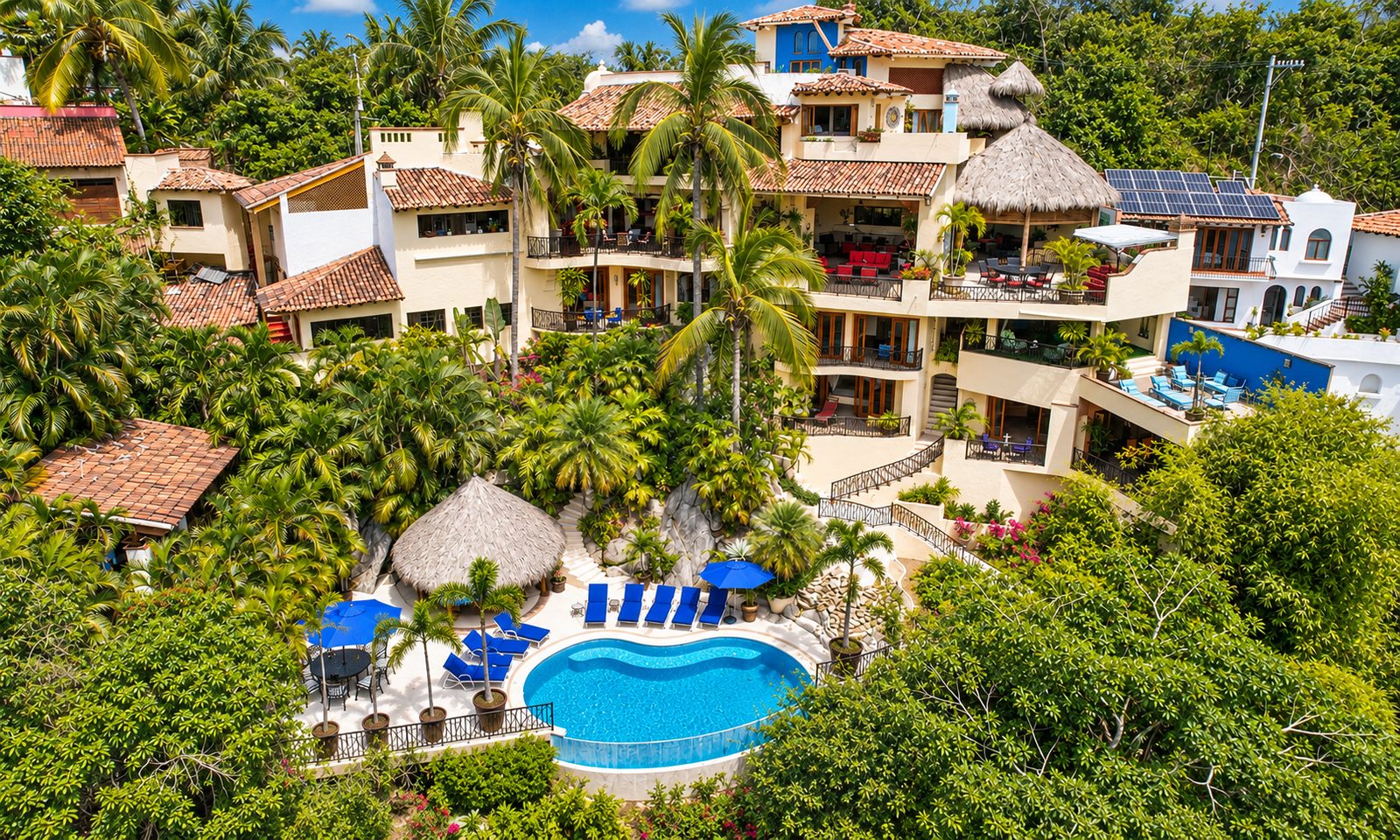 Aerial view of Casa Kalista's terraced levels, palapa and pool on the Lomas de Mismaloya hillside