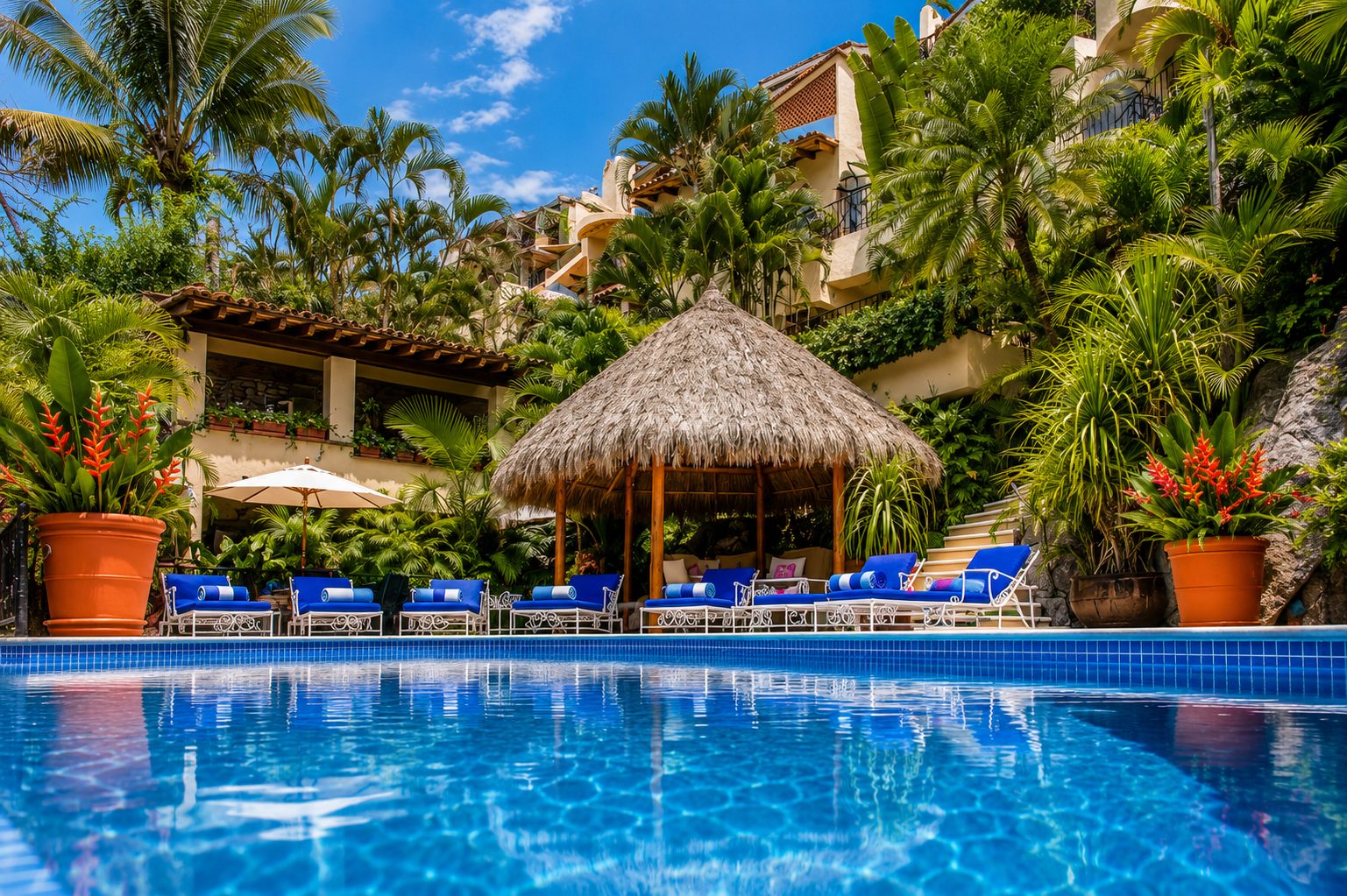 Pool-level view toward the palapa and terraced gardens at Casa Kalista
