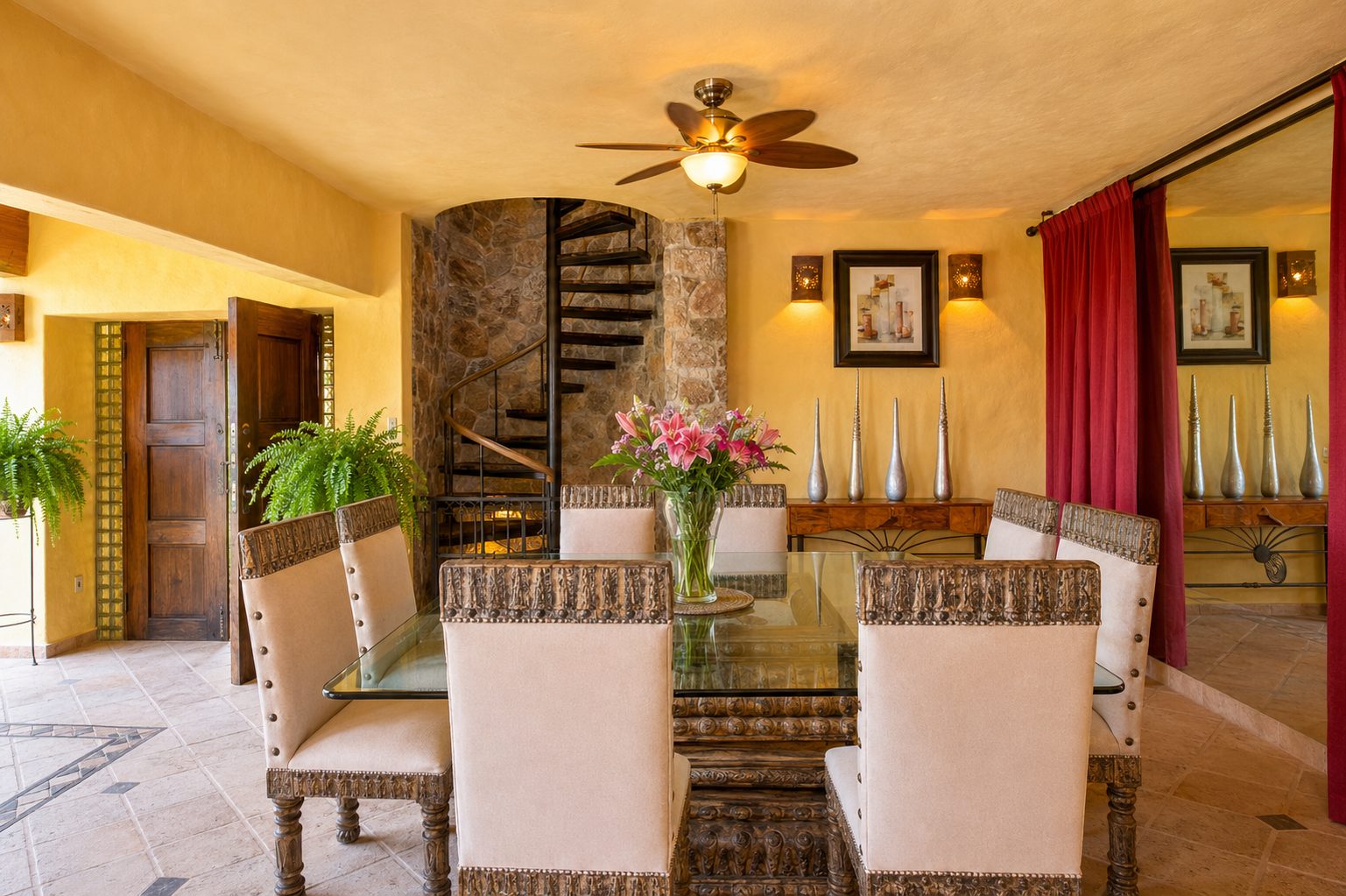 Dining area with stone spiral staircase and carved wood doors