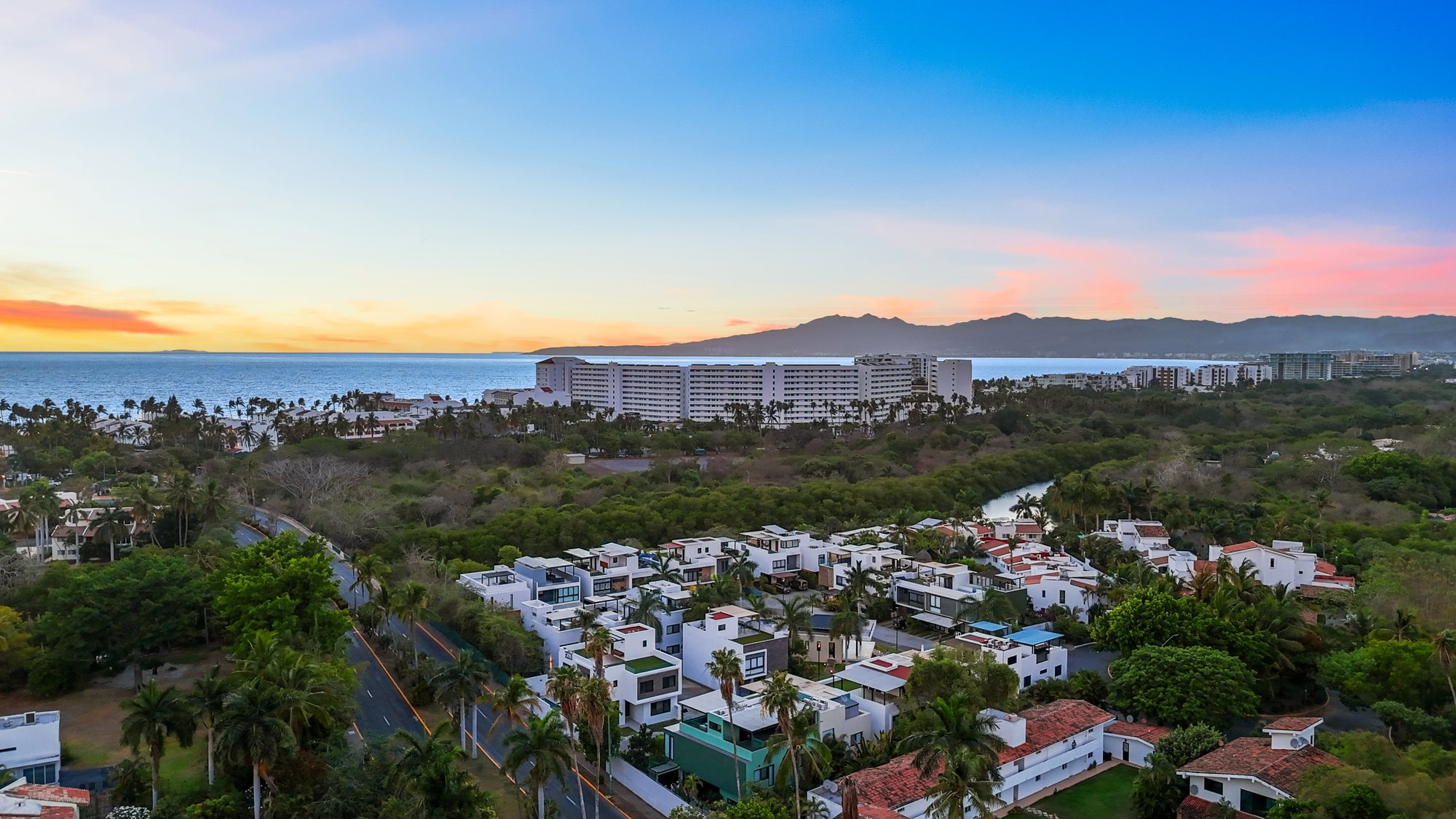 Vista aérea al atardecer sobre la comunidad, el río y la bahía